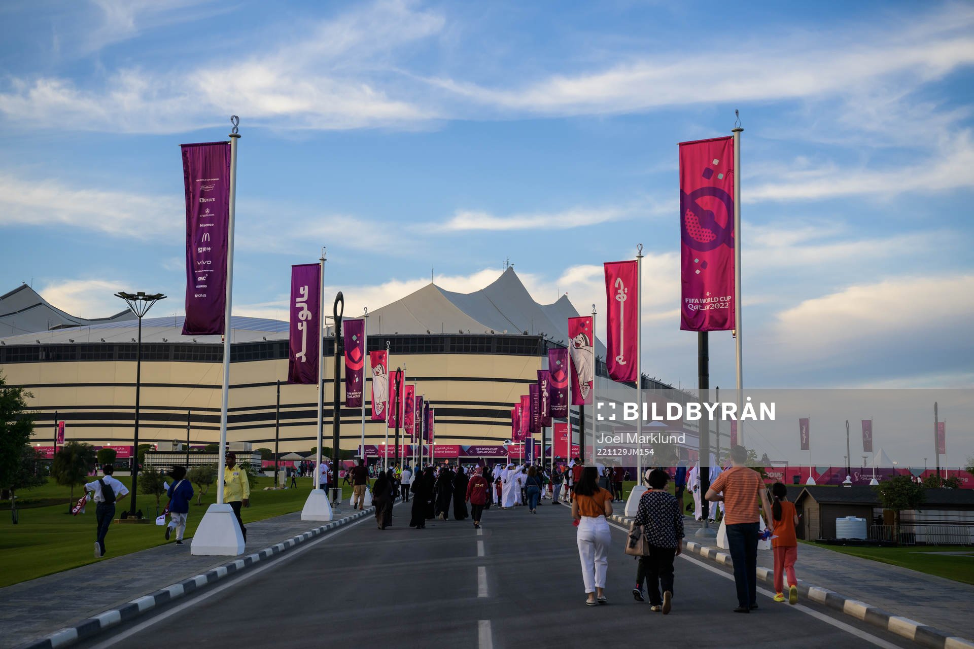 Spectators walking toward Al Bayt Stadium
