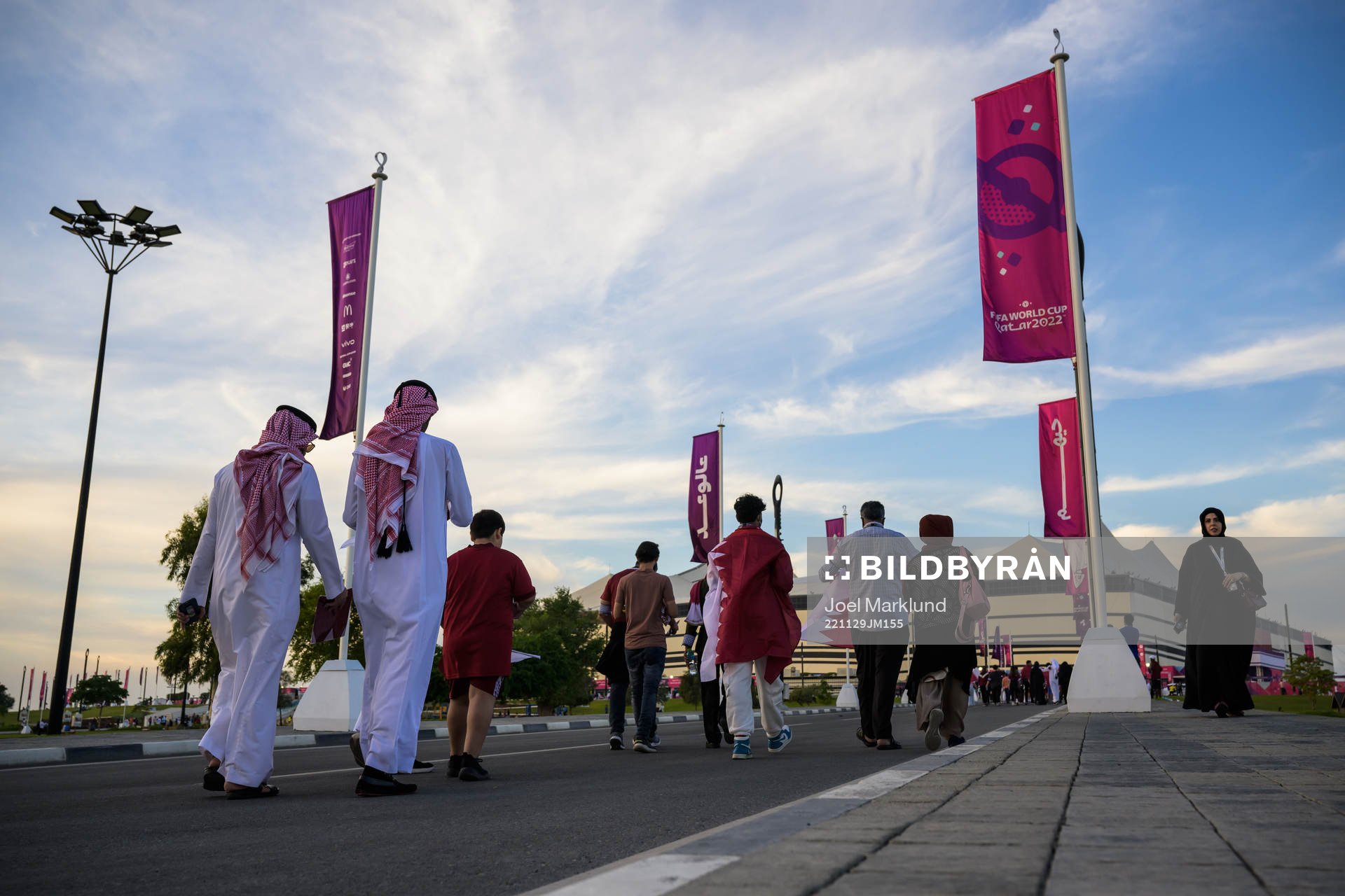 Spectators walking toward Al Bayt Stadium