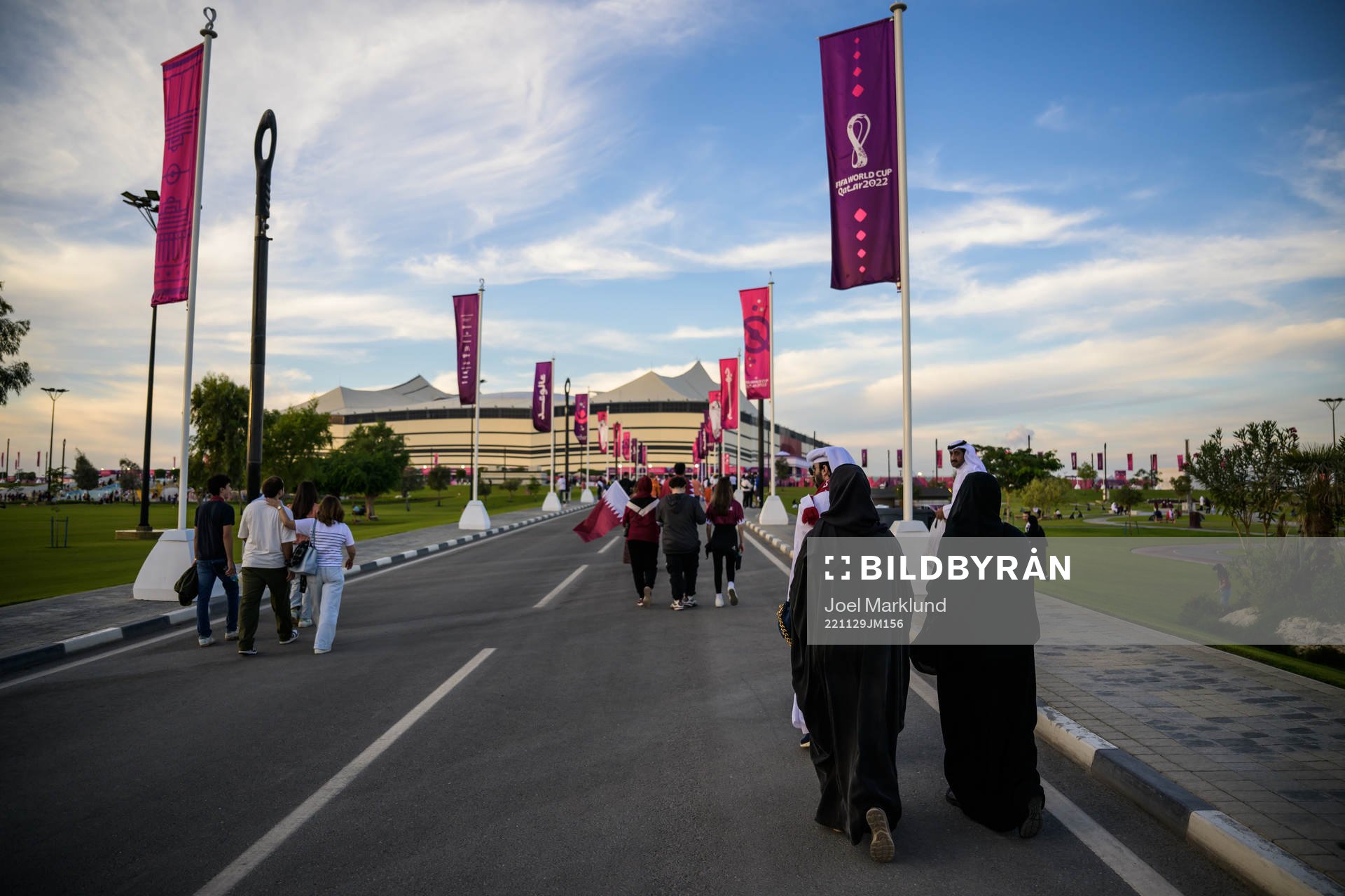 Spectators walking toward Al Bayt Stadium