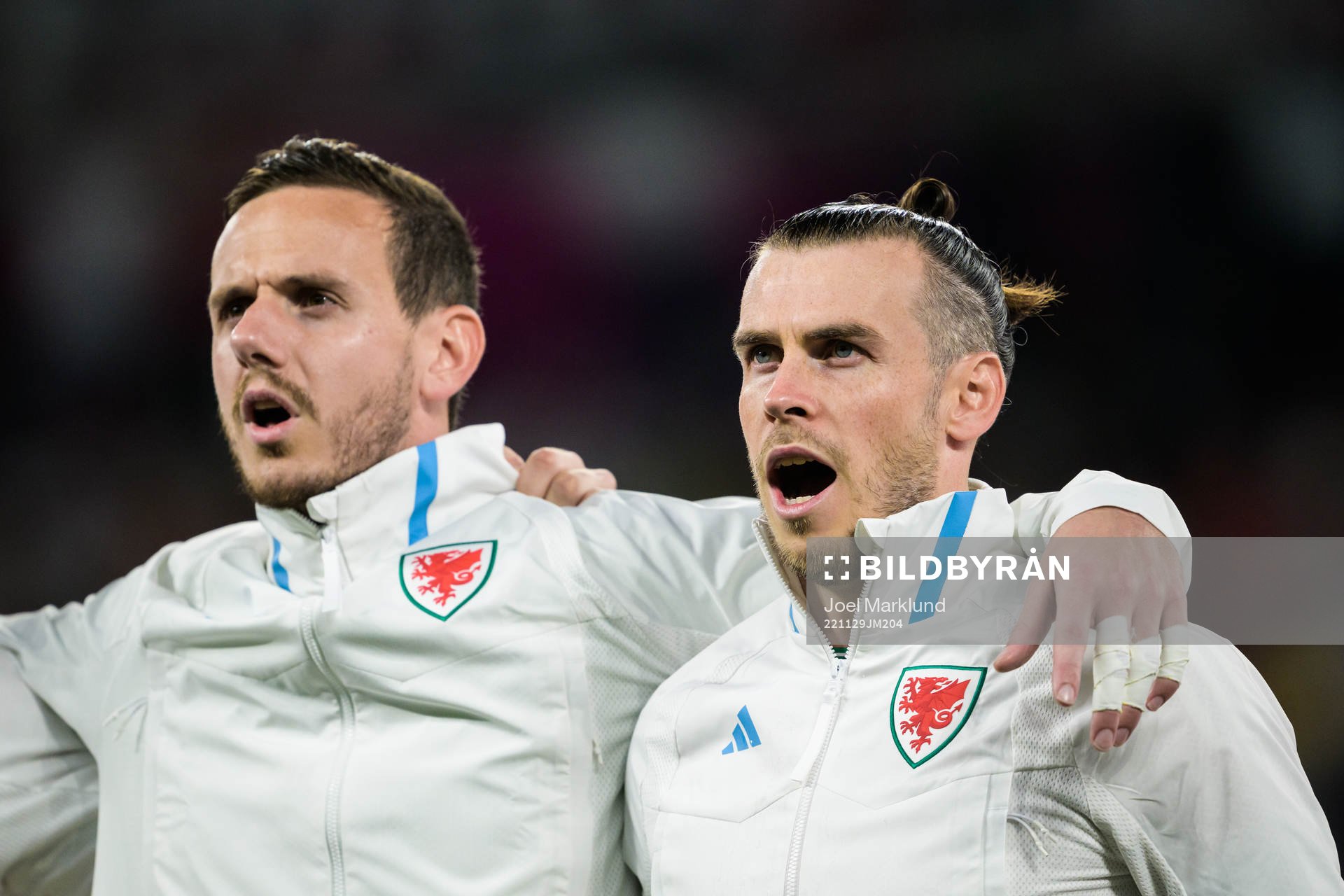 Goalkeeper Danny Ward and Gareth Bale of Wales singing the