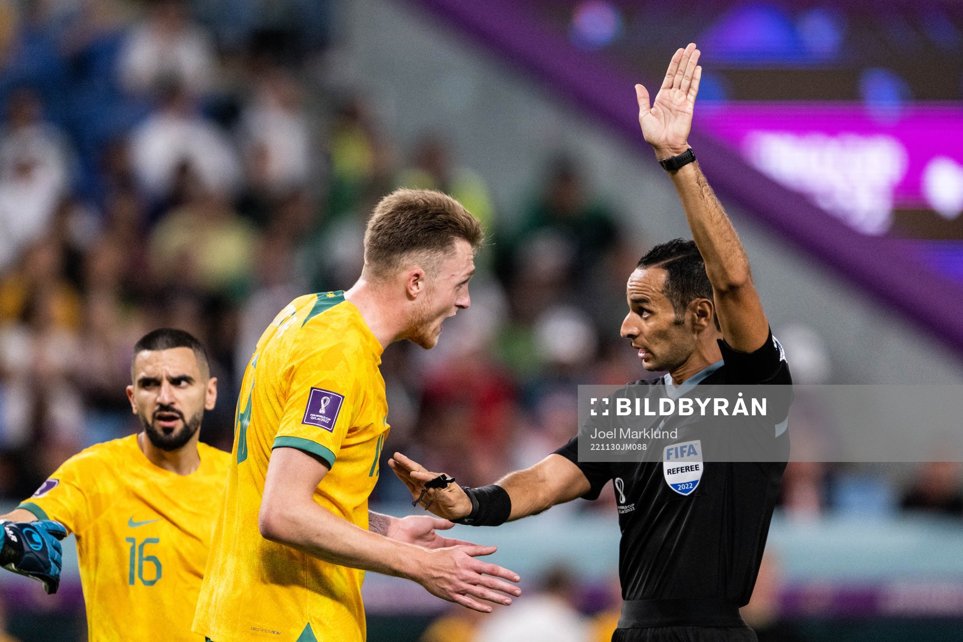 Harry Souttar of Australia and referee Mustapha Ghorbal