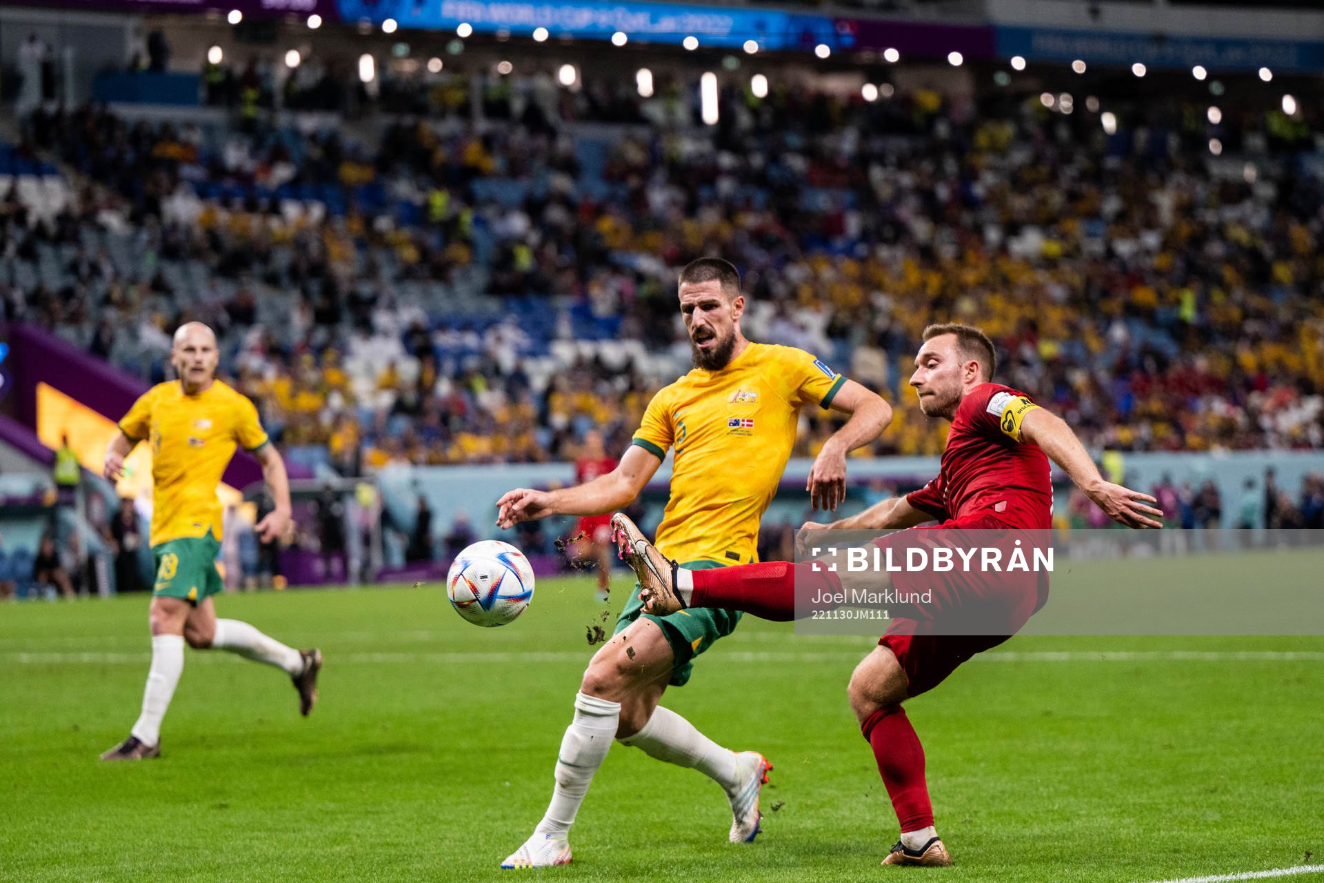 Milos Degenek of Australia and Christian Eriksen of Denmark