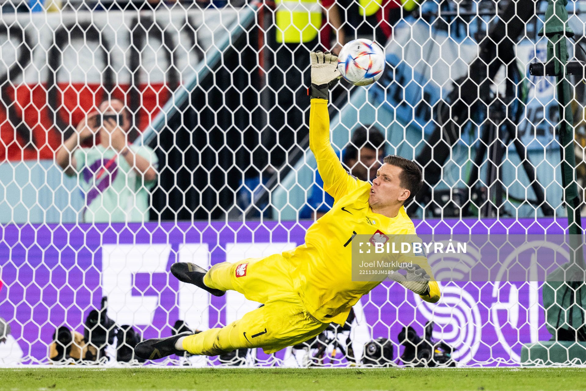 Goalkeeper Wojciech Szczesny of Poland saves a penalty