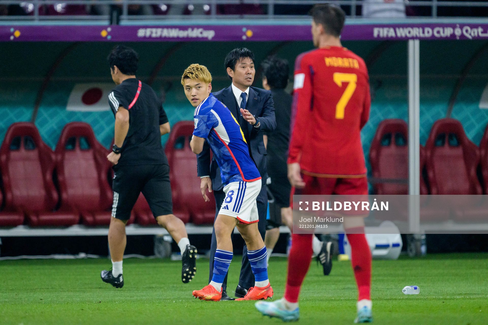 Ritsu Doan and head coach Hajime Moriyasu of Japan celebrate