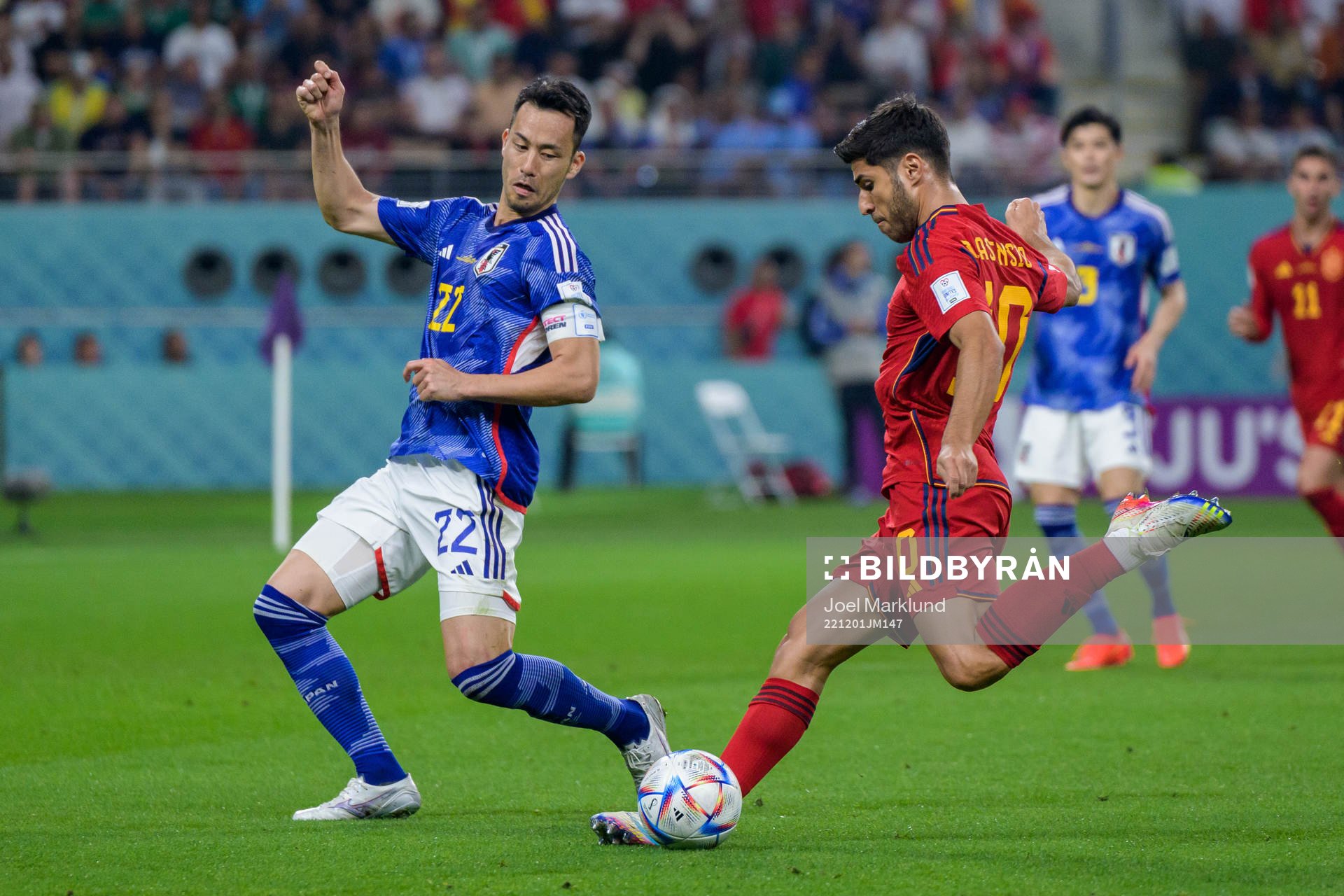 Maya Yoshida of Japan and Marco Asensio of Spain