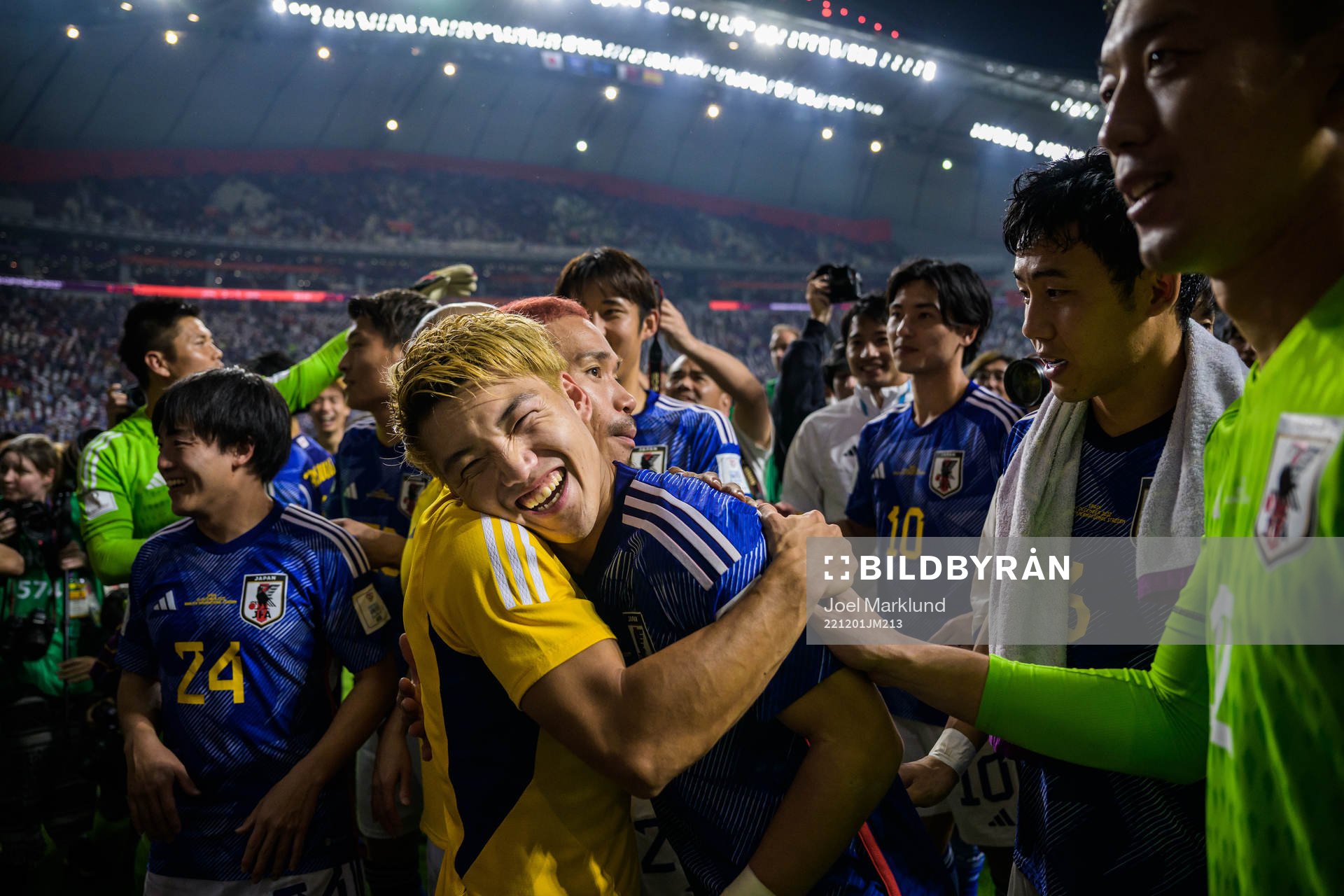 Yuto Nagatomo hugs Ritsu Doan of Japan as the team celebrate