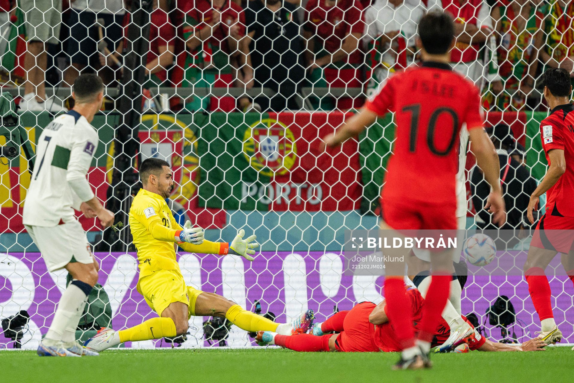 Younggwon Kim of South Korea scores the 1-1 goal behind