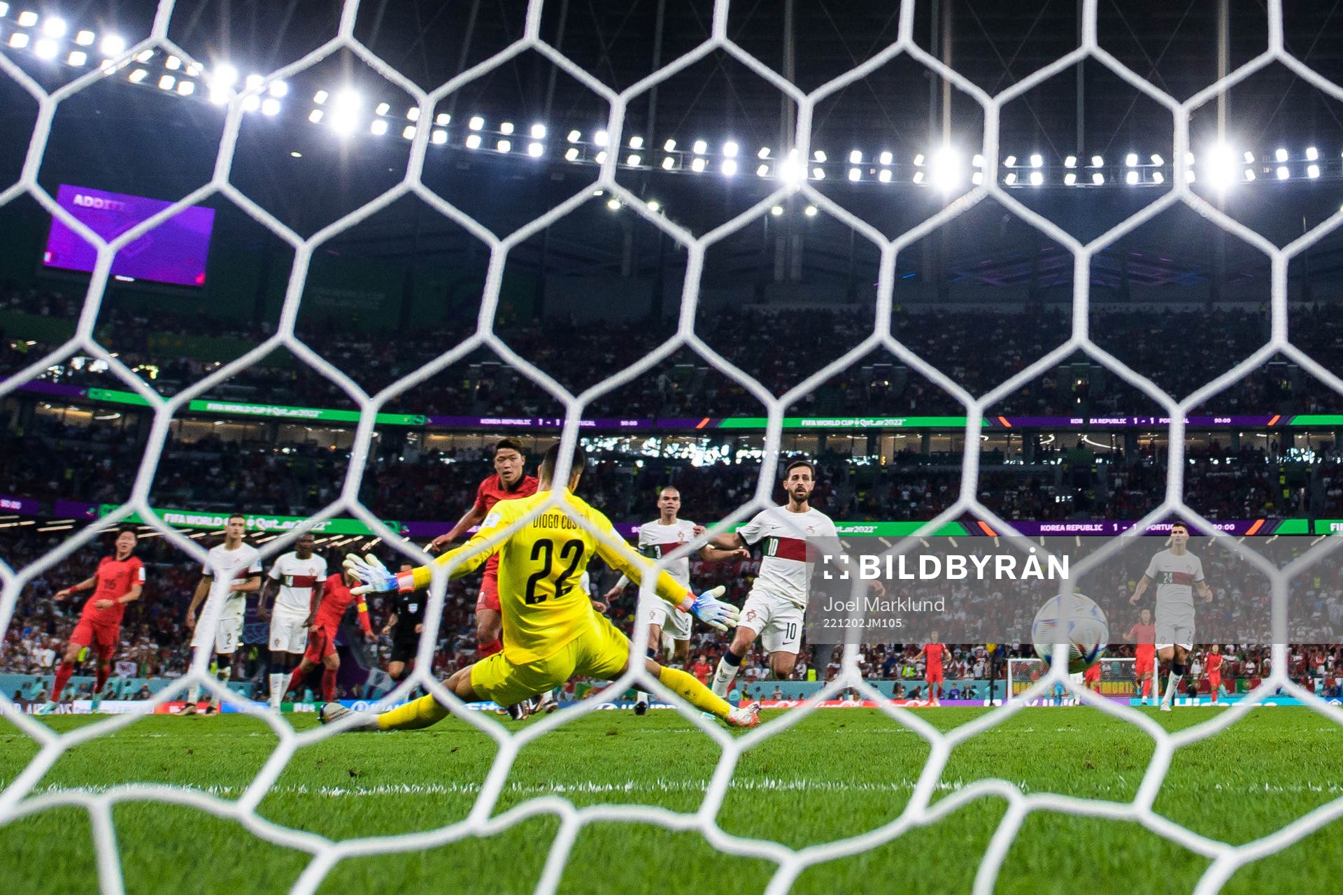 Heechan Hwang of South Korea scores 2-1 behind goalkeeper