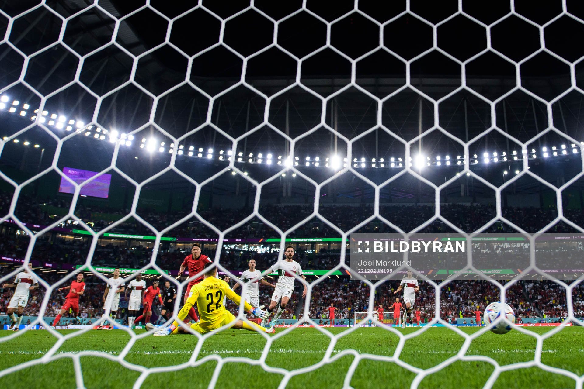 Heechan Hwang of South Korea scores 2-1 behind goalkeeper