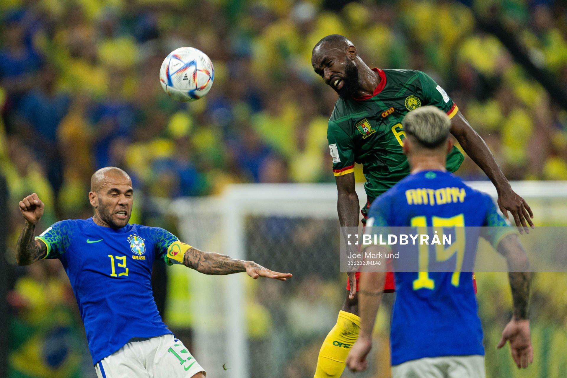 Dani Alves of Brazil and Nicolas Moumi Ngamaleu of Cameroon