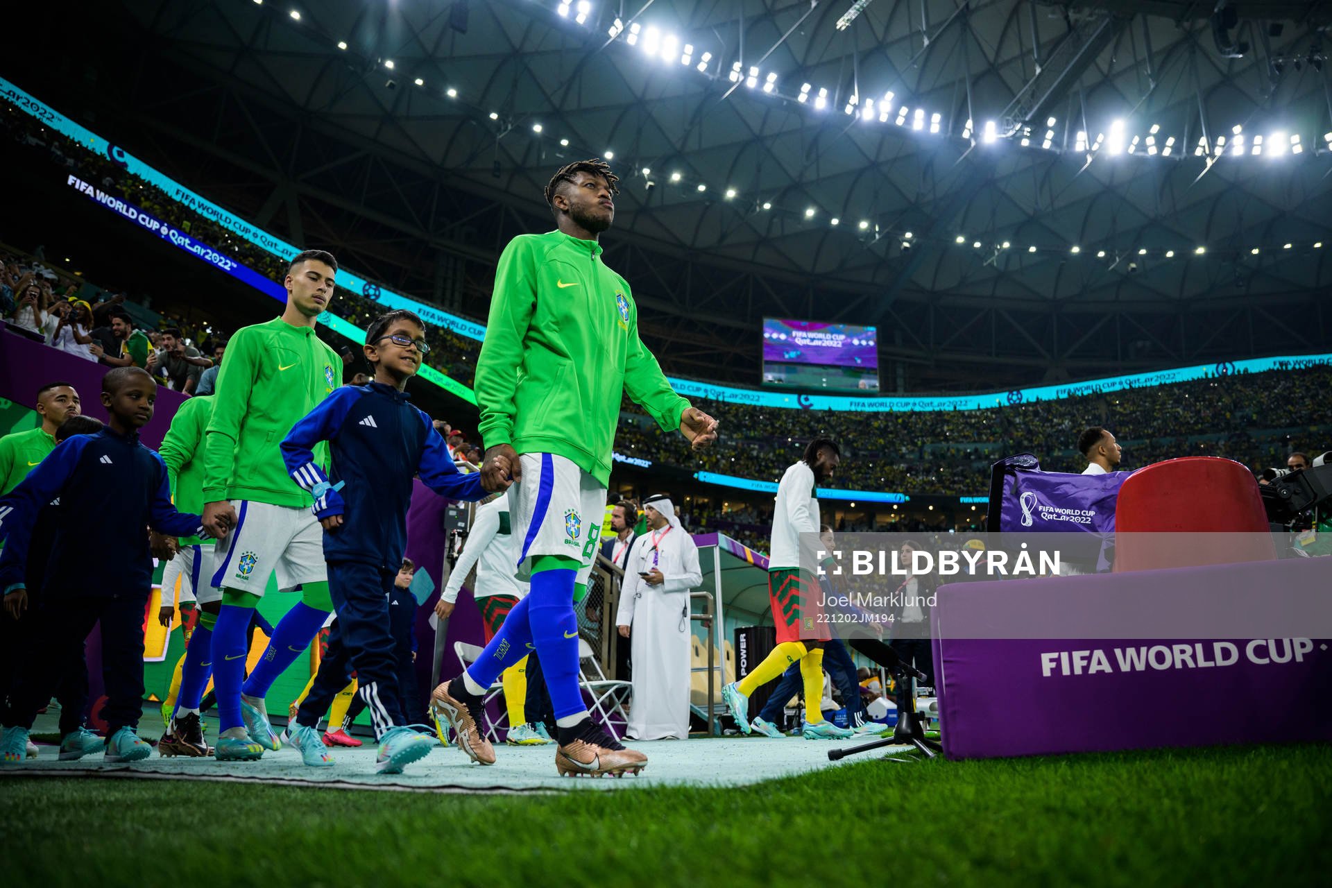 Gabriel Martinelli and Fred of Brazil entering the pitch