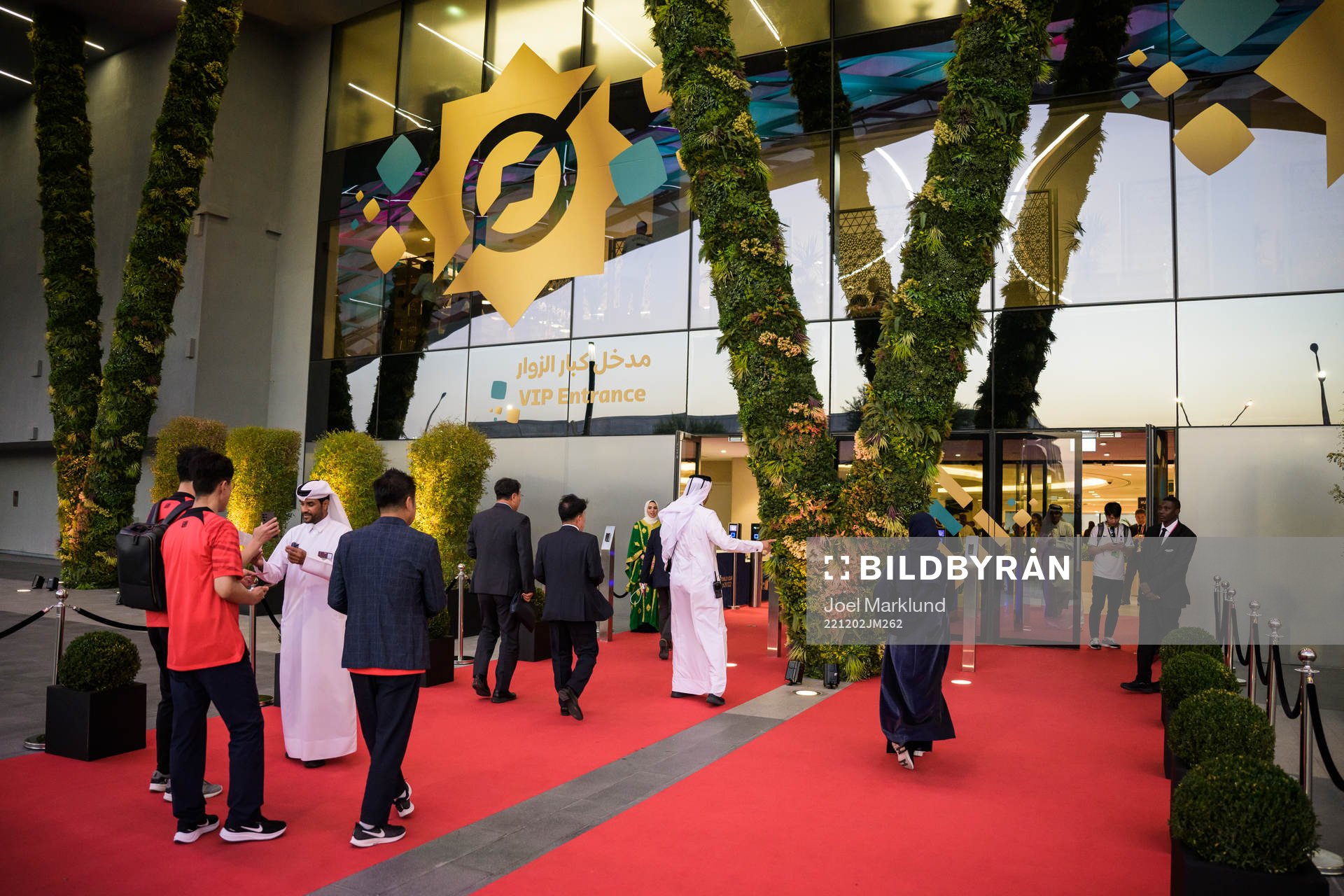 Spectators walk at a red carpet to the VIP entrance