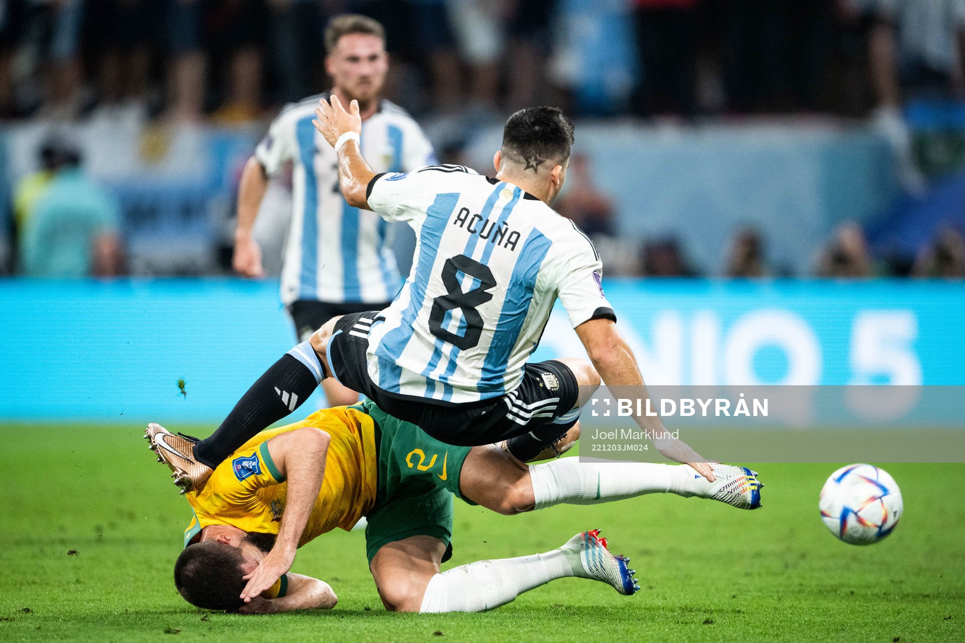 Milos Degenek of Australia and Marcos Acuna of Argentina