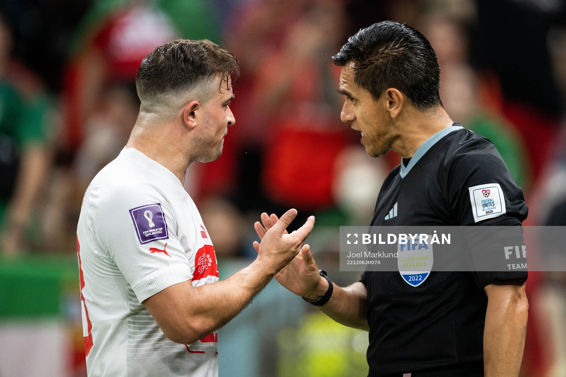 Xherdan Shaqiri of Switzerland argues with linesman