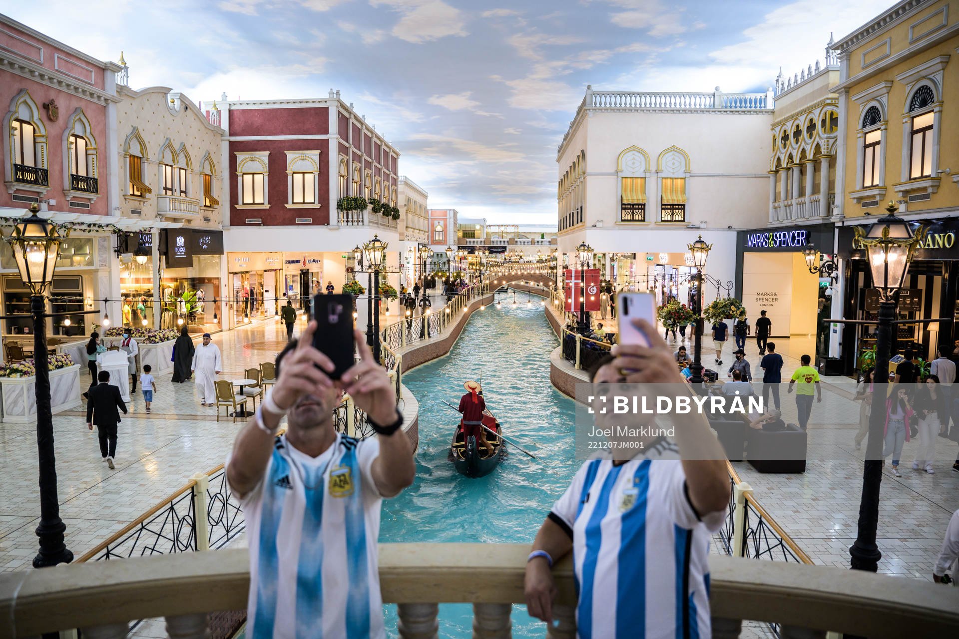 Men in Argentina jerseys take selfies as a gondola passes