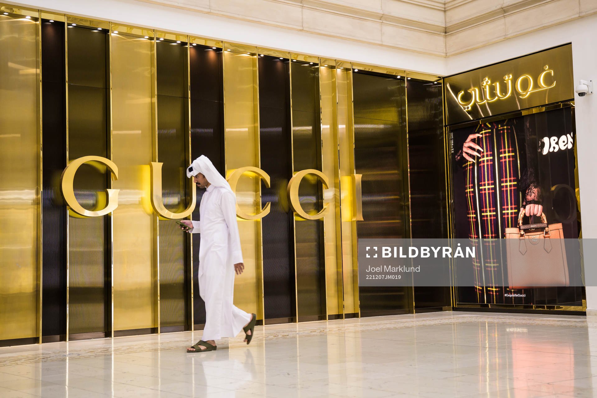 A man walks past a Gucci store at Villaggio Mall