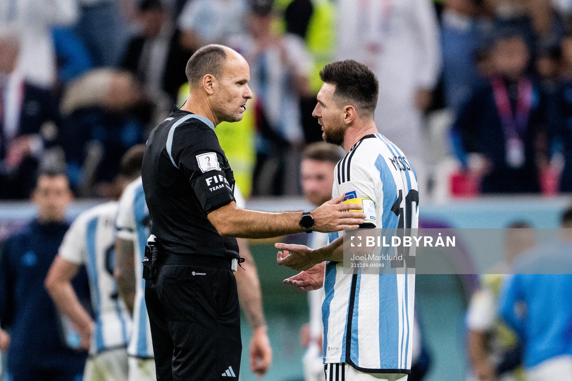 Referee Antonio Mateu Lahoz and Lionel Messi of Argentina