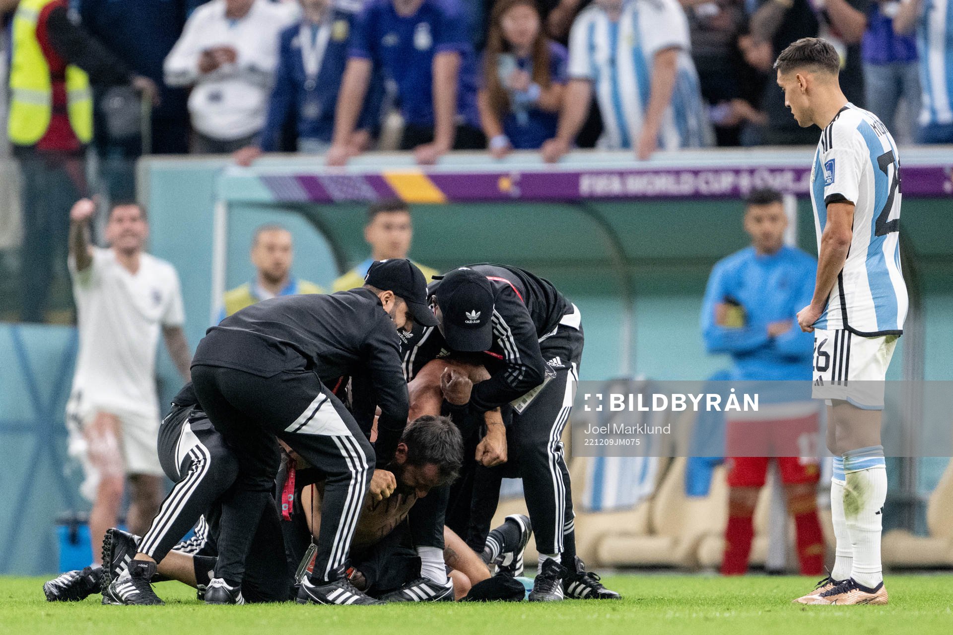 A pitch invader is detained by security