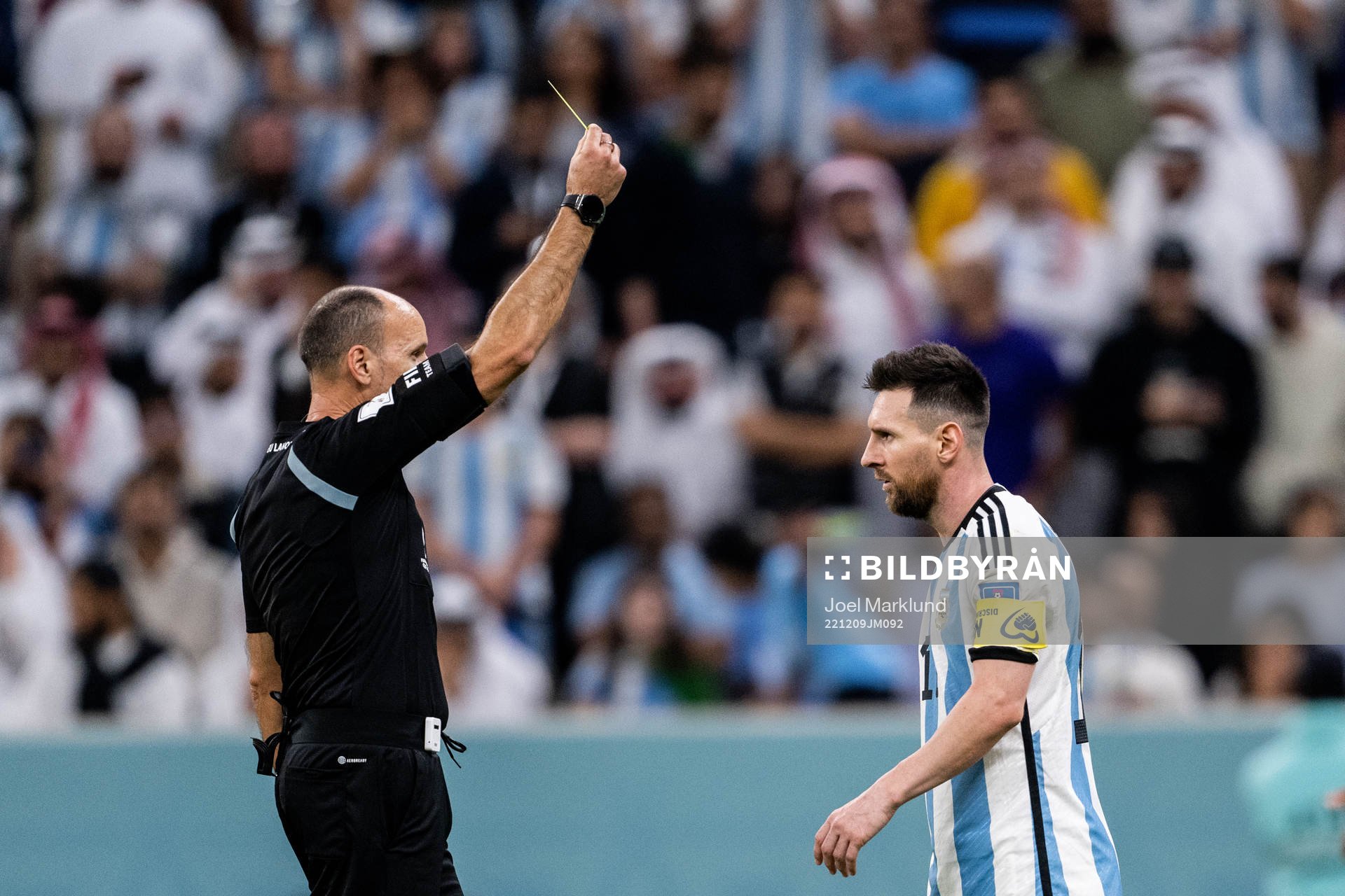 Lionel Messi of Argentina is shown a yellow card by referee