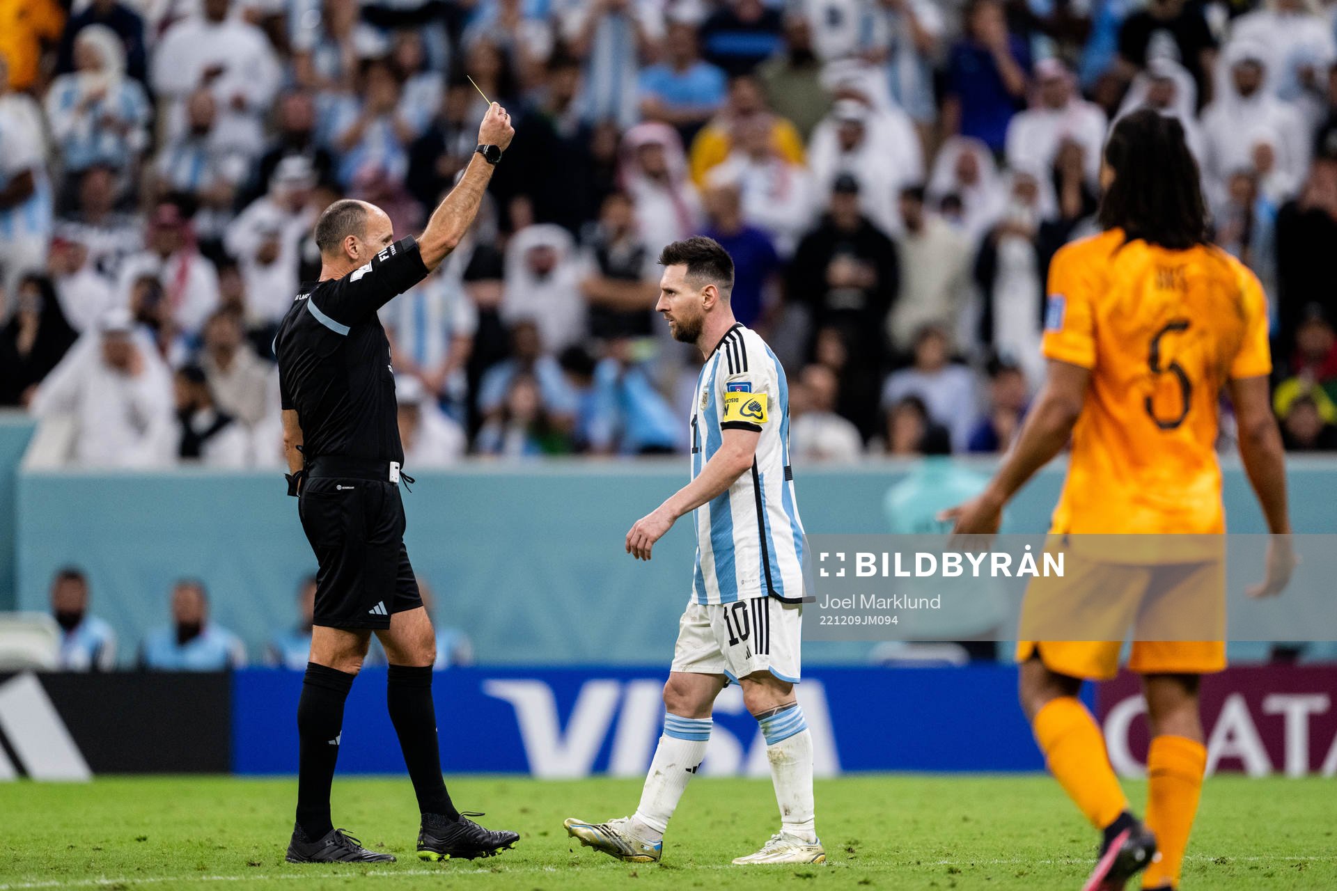 Lionel Messi of Argentina is shown a yellow card by referee