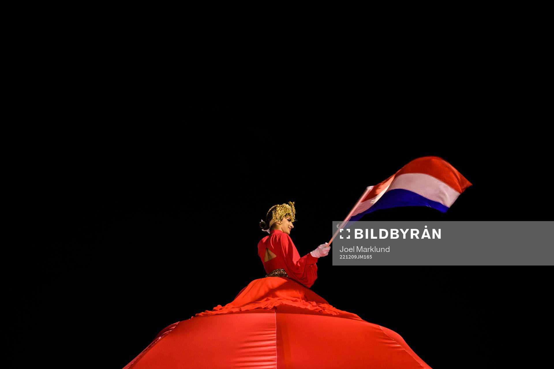 A performer waves a Dutch flag