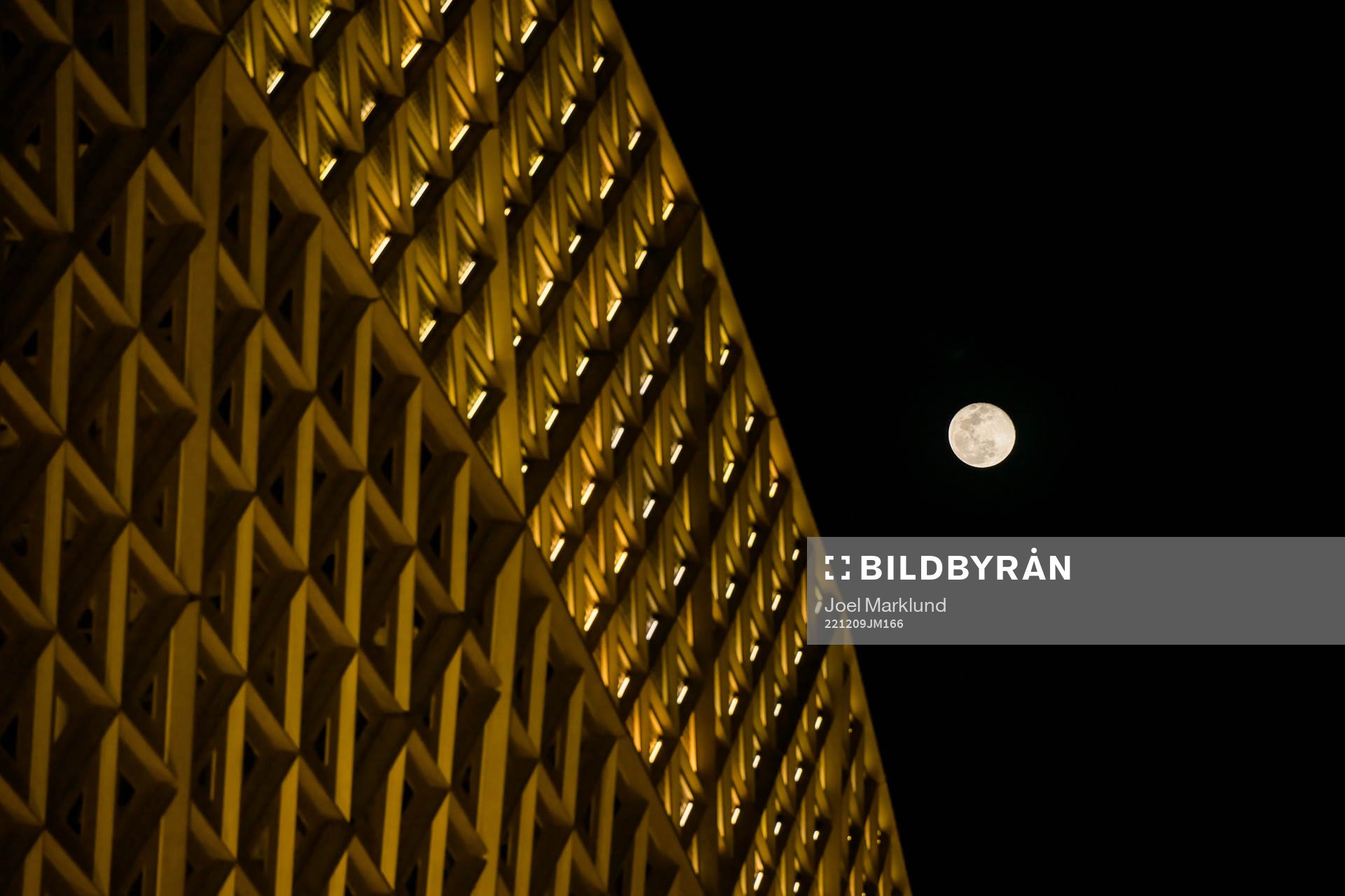 A full moon is seen behind Lusail Stadium