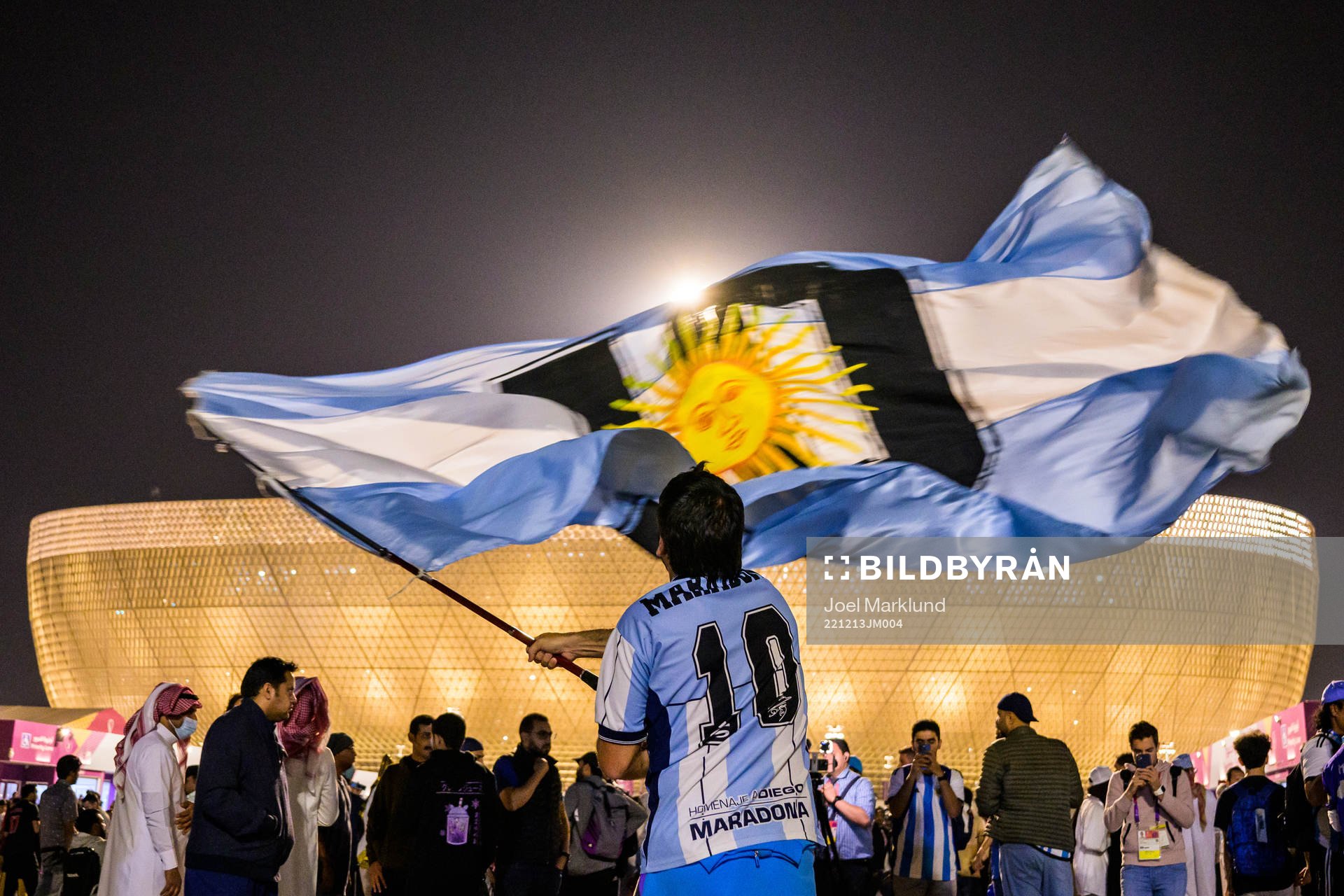 A man with a Diego Maradona jersey waves a modified