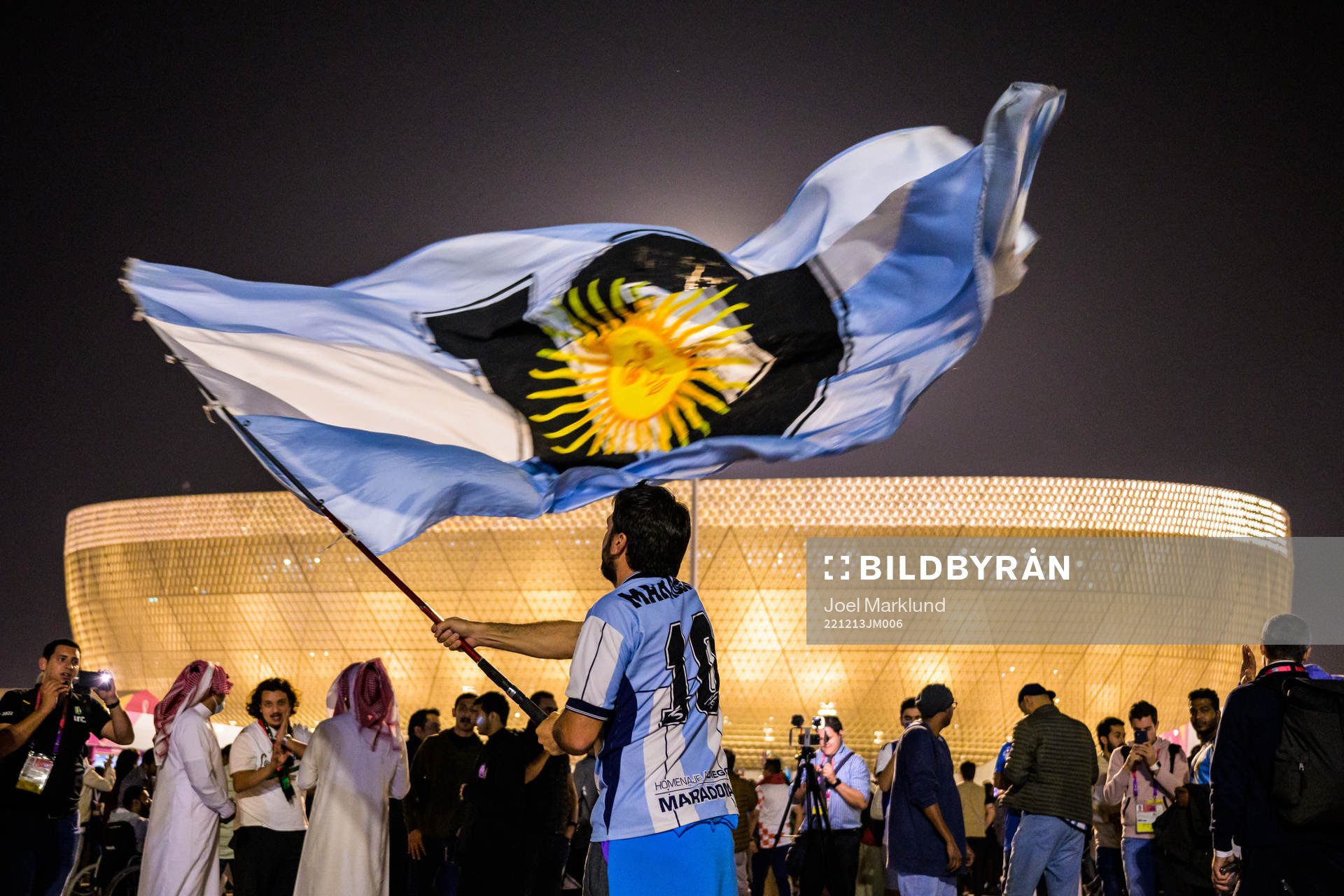 A man with a Diego Maradona jersey waves a modified