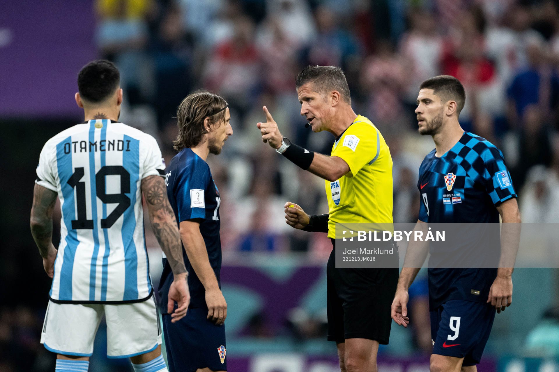 Luka Modric of Croatia and  referee Daniele Orsato