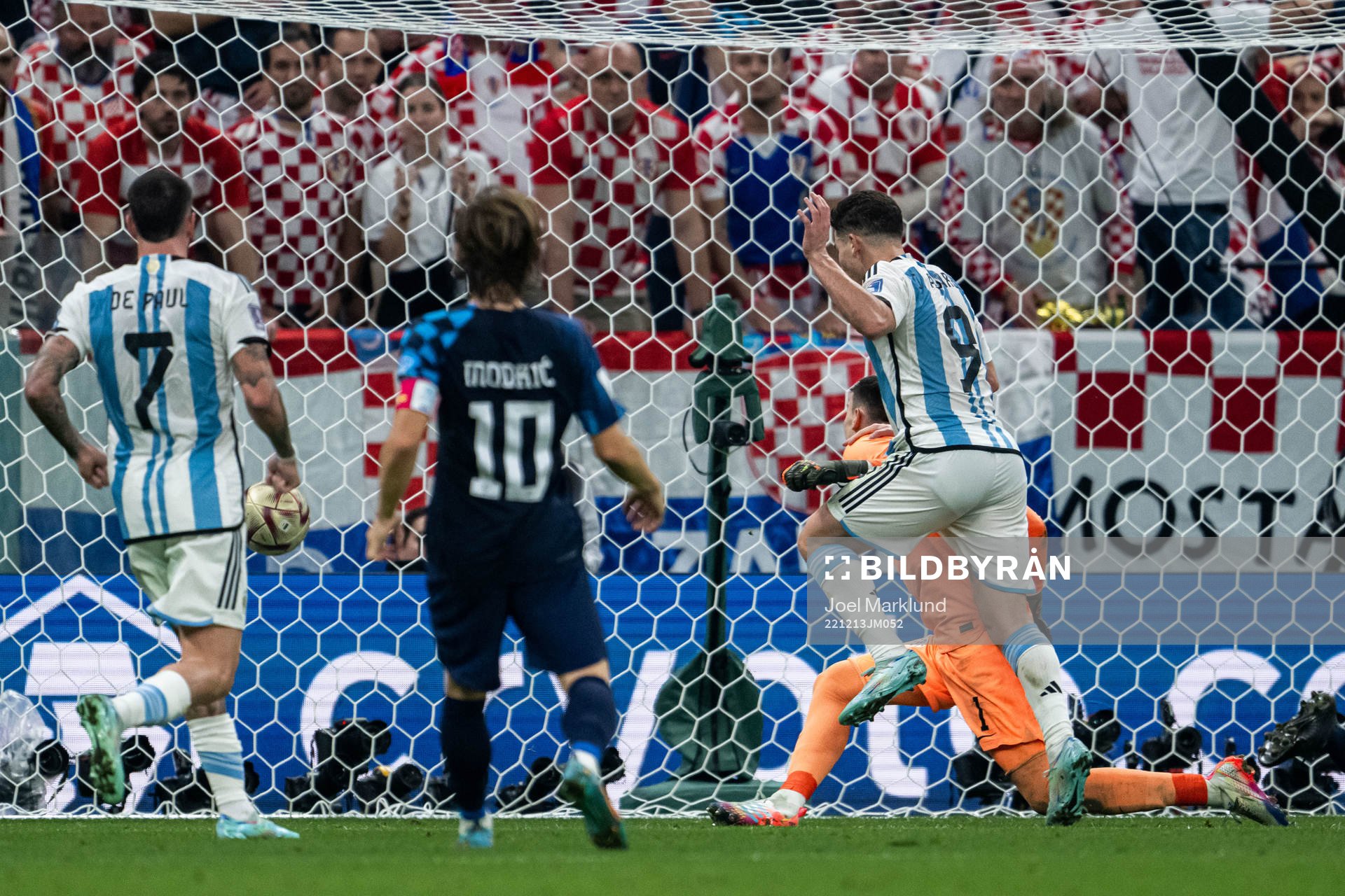 Julian Alvarez of Argentina scores the 2-0 goal behind goalkeeper Dominik Livakovic of Croatia during the FIFA World Cup 2022 semifinal between Argentina and Croatia on December 13, 2022 in Doha. 