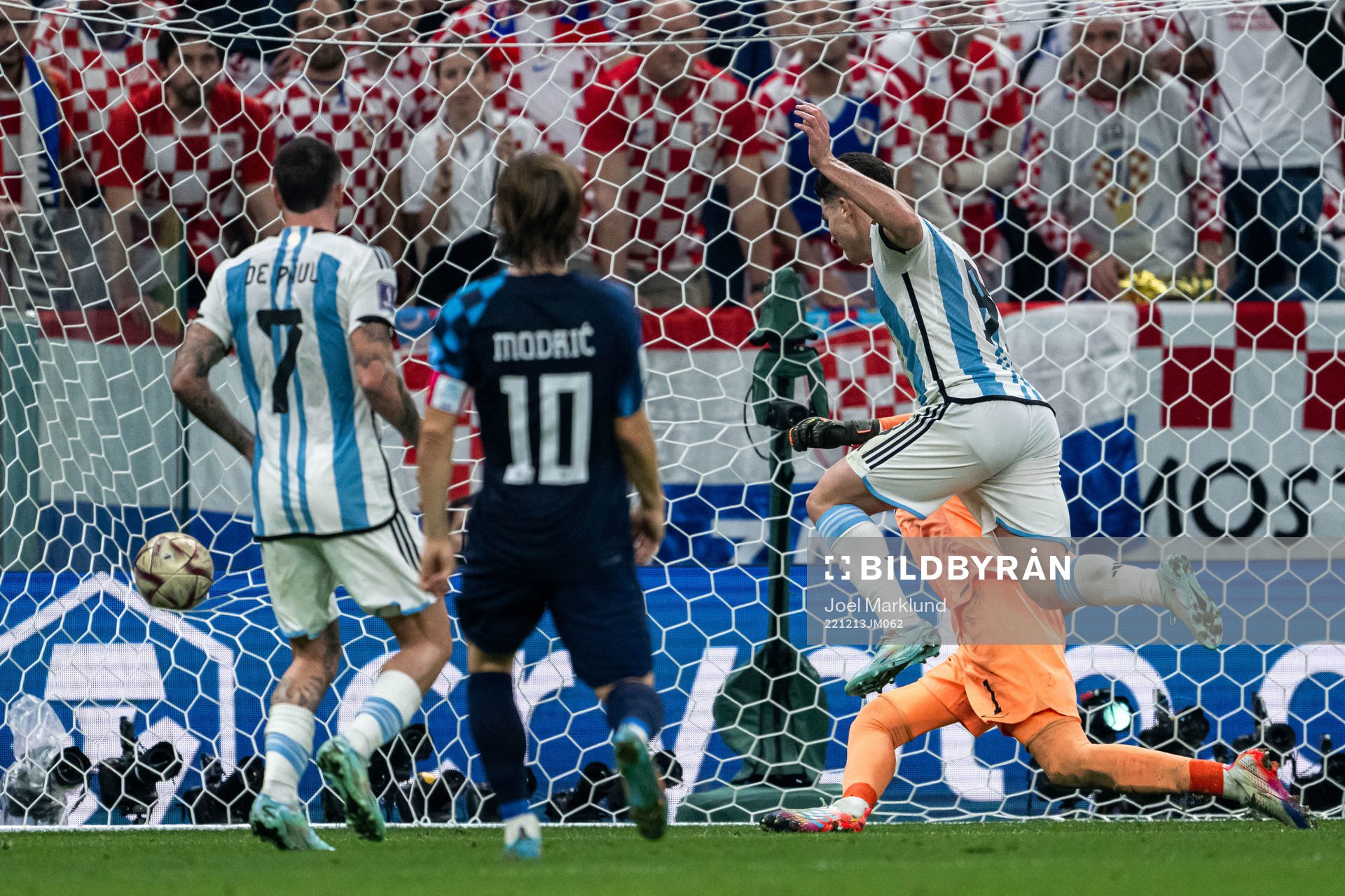 Julian Alvarez of Argentina scores the 2-0 goal behind goalkeeper Dominik Livakovic of Croatia during the FIFA World Cup 2022 semifinal between Argentina and Croatia on December 13, 2022 in Doha.