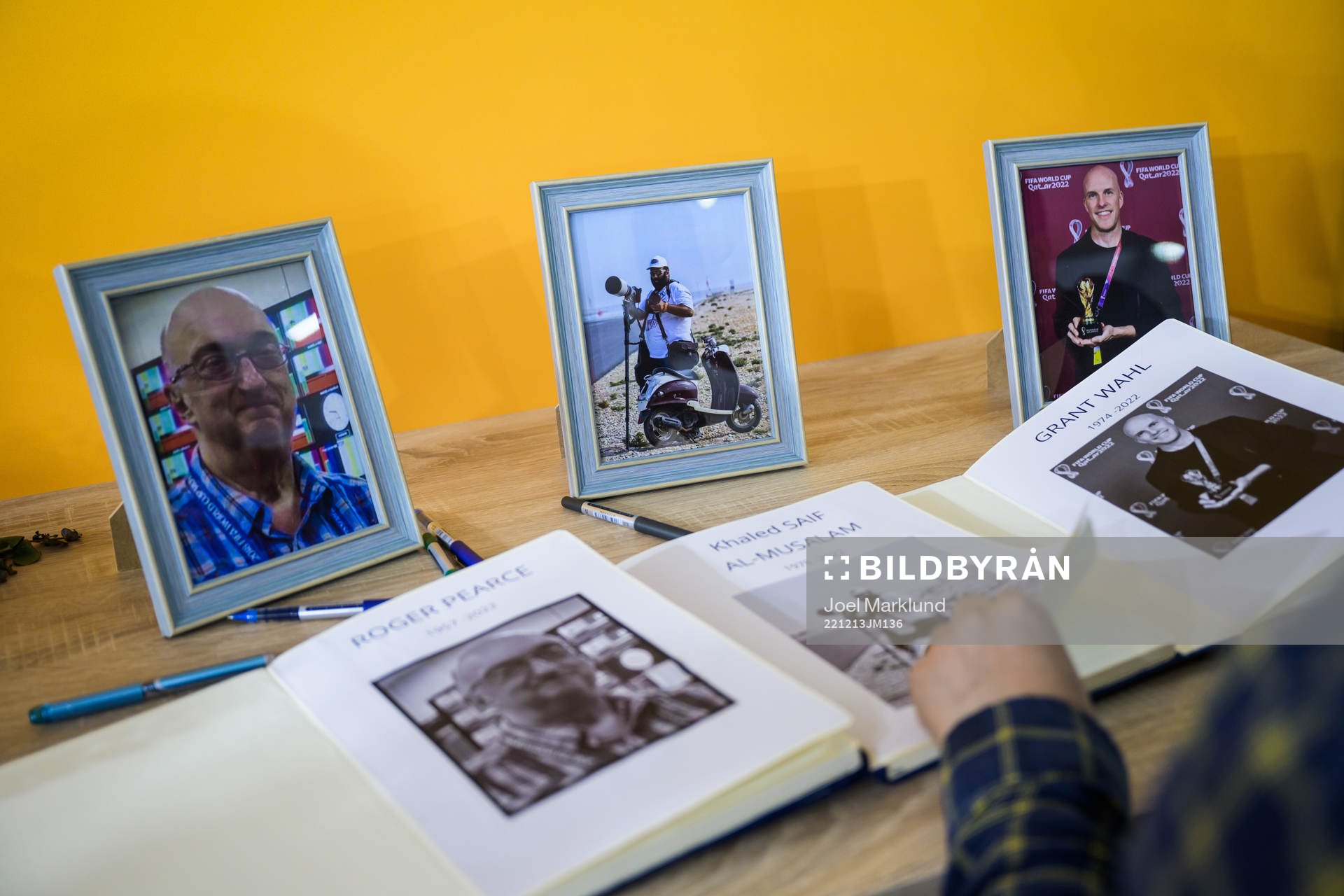 A journalist turn pages in a condolence book for the