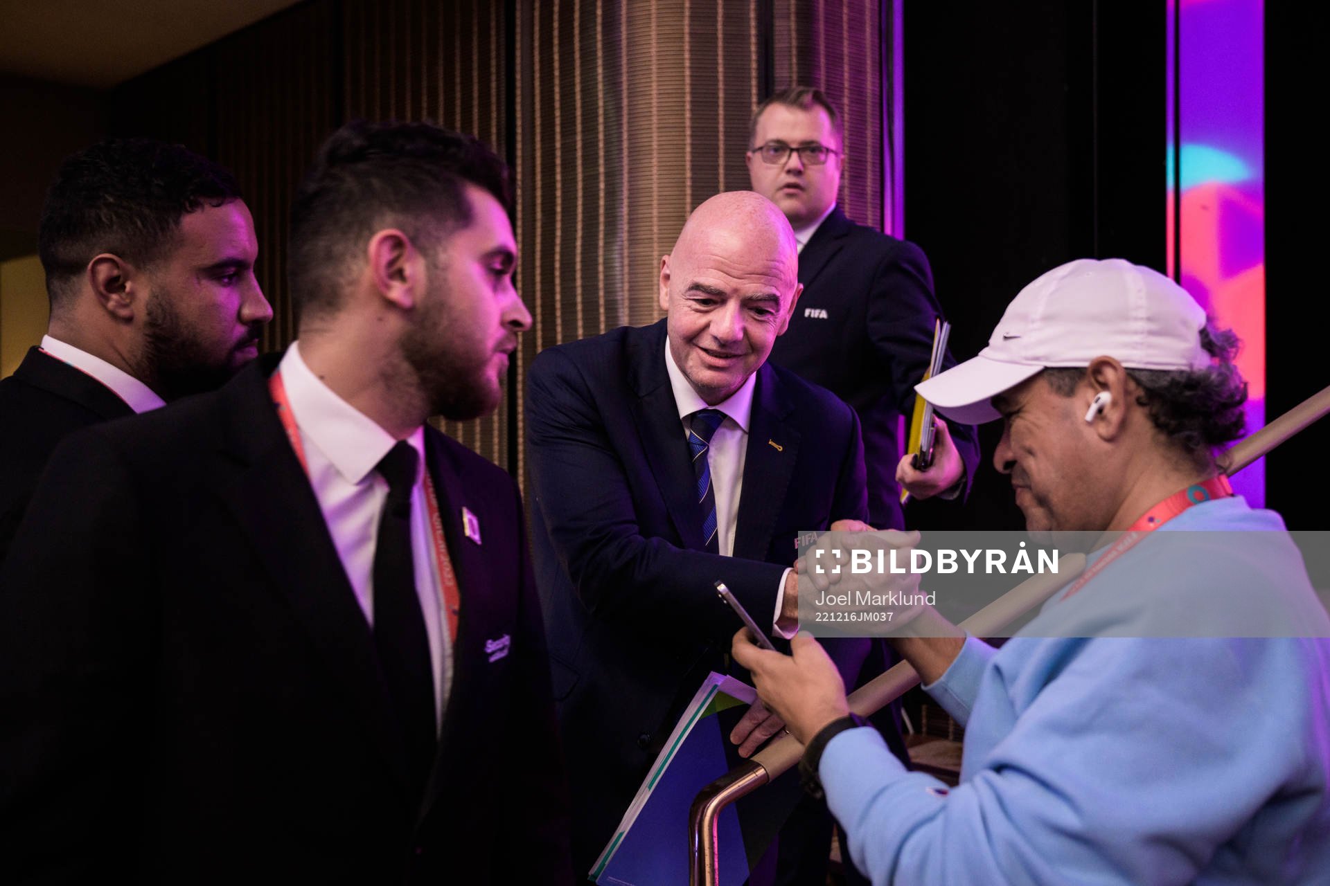 A member of media greets Gianni Infantino, president of FIFA