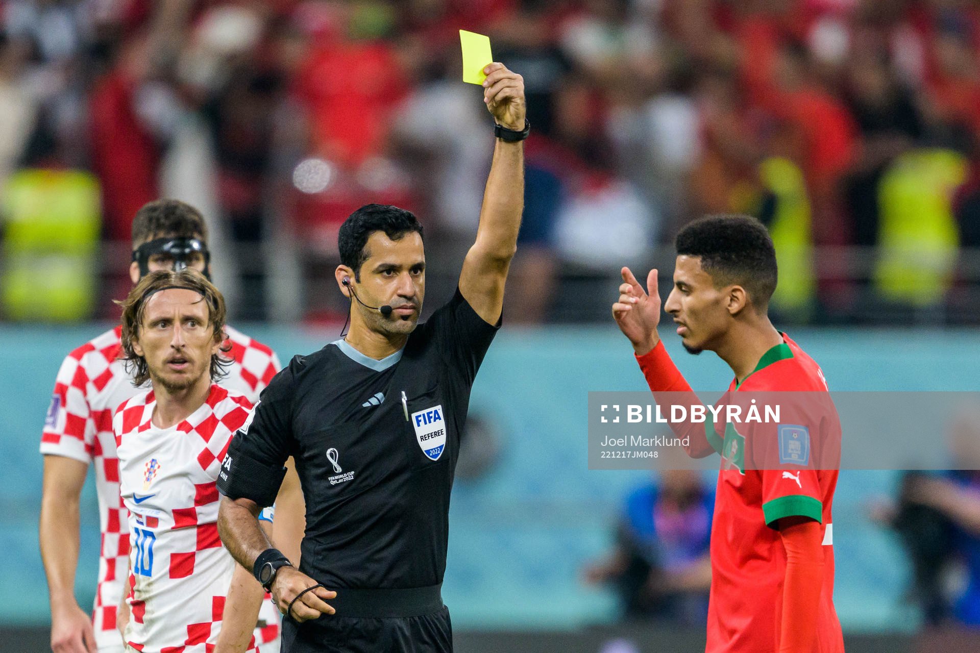Referee Abdulrahman Al Jassim shows a yellow card to Azzedine Ounahi of Morocco during the FIFA World Cup 2022 bronze medal match between Croatia and Morocco on December 17, 2022 in Doha.
