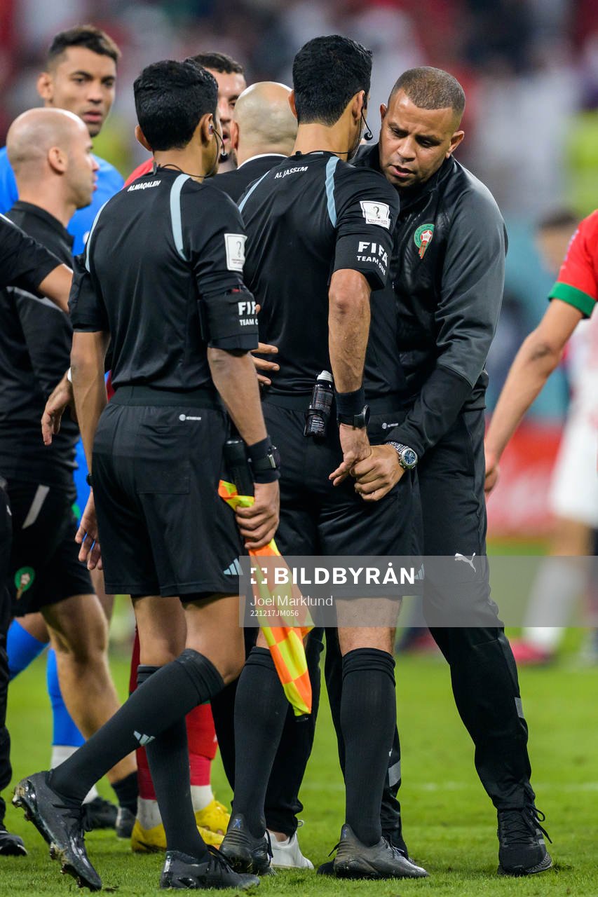 A staff member of Morocco obstructs Referee Abdulrahman Al Jassim from showing a yellow card after the FIFA World Cup 2022 bronze medal match between Croatia and Morocco on December 17, 2022 in Doha.