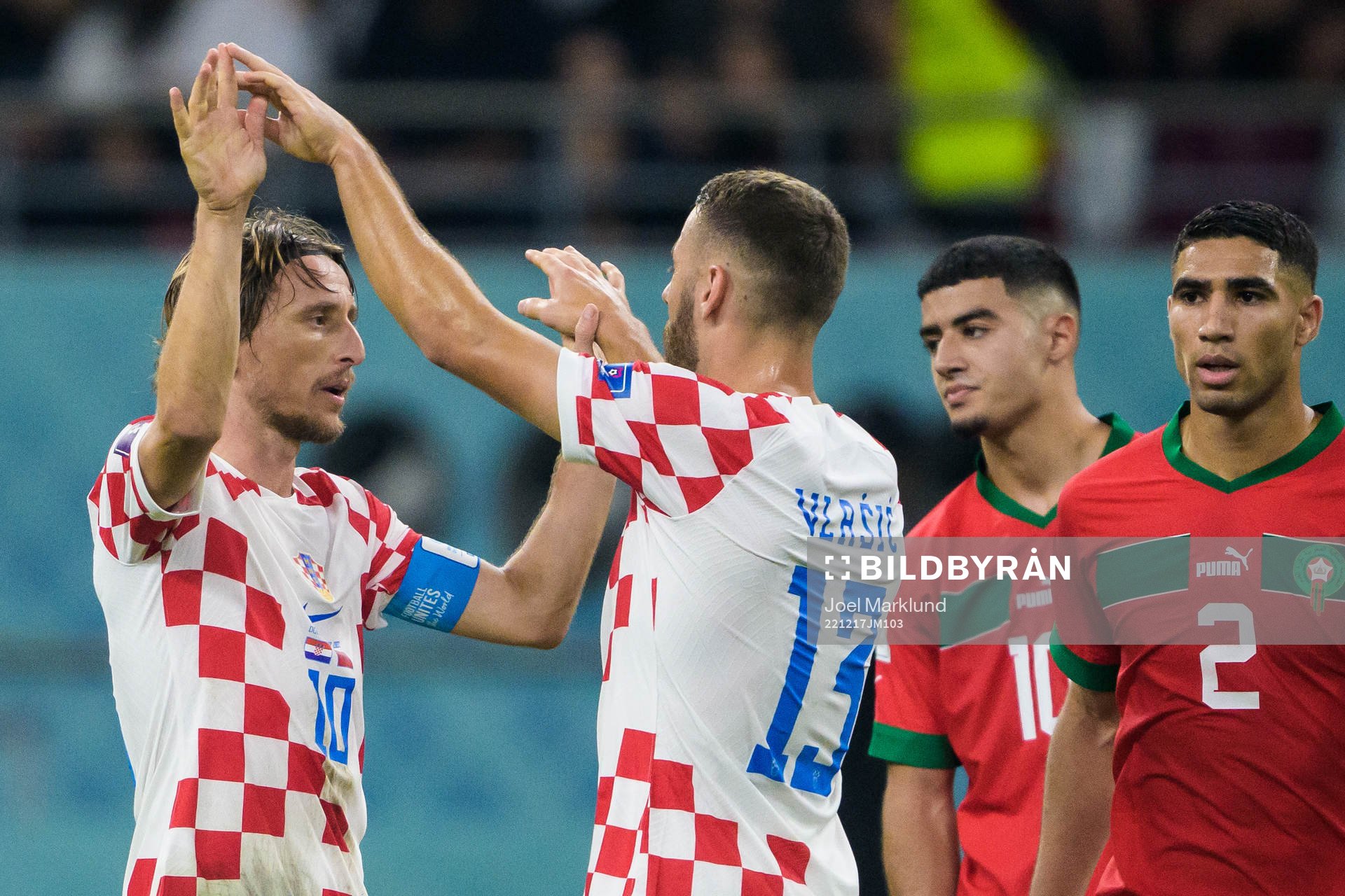 Luka Modric and Nikola Vlasic of Croatia celebrate in front