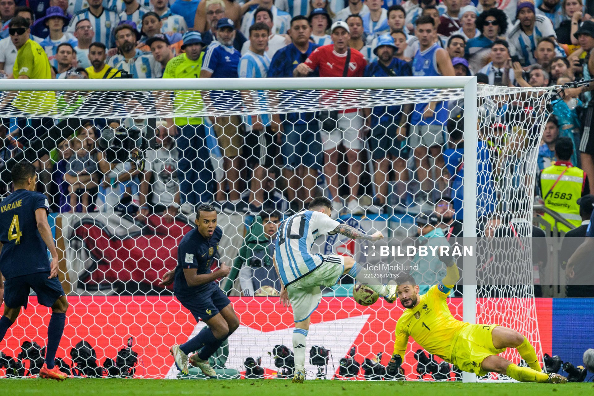 Lionel Messi of Argentina scores 3-2 on Jules Kounde and goalkeeper Hugo Lloris of France during the FIFA World Cup 2022 final between Argentina and France on December 18, 2022 in Doha.