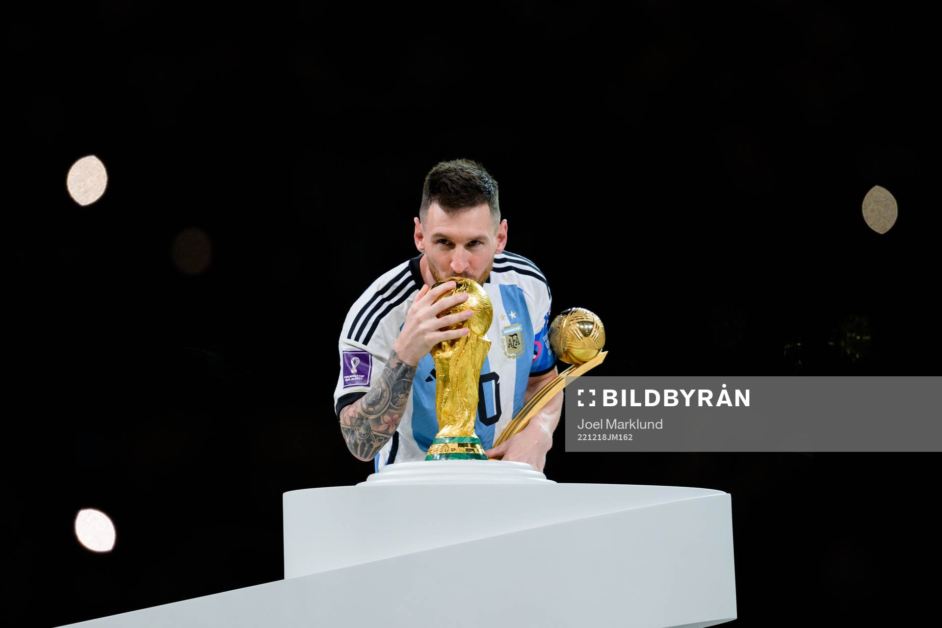 Lionel Messi of Argentina kisses the FIFA World Cup Trophy