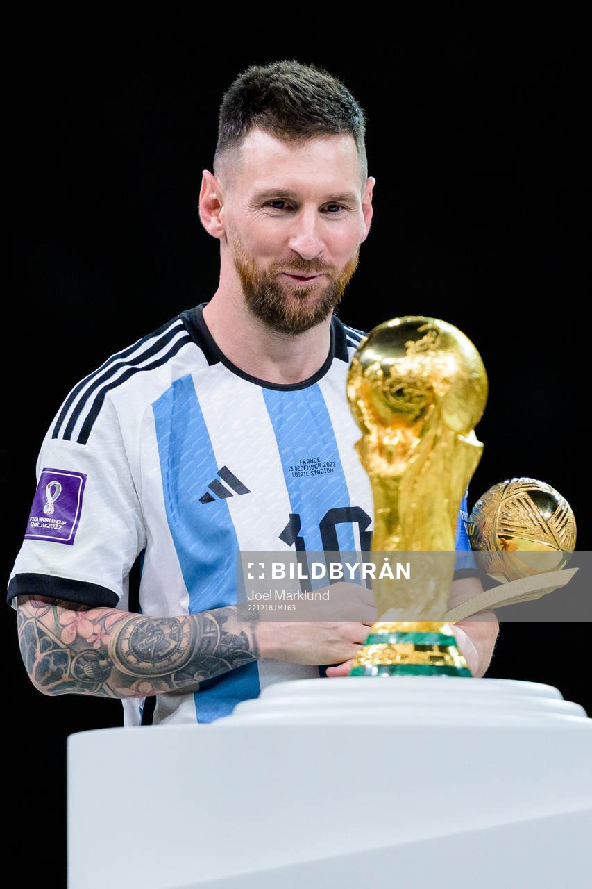 Lionel Messi of Argentina looks at the FIFA World Cup Trophy