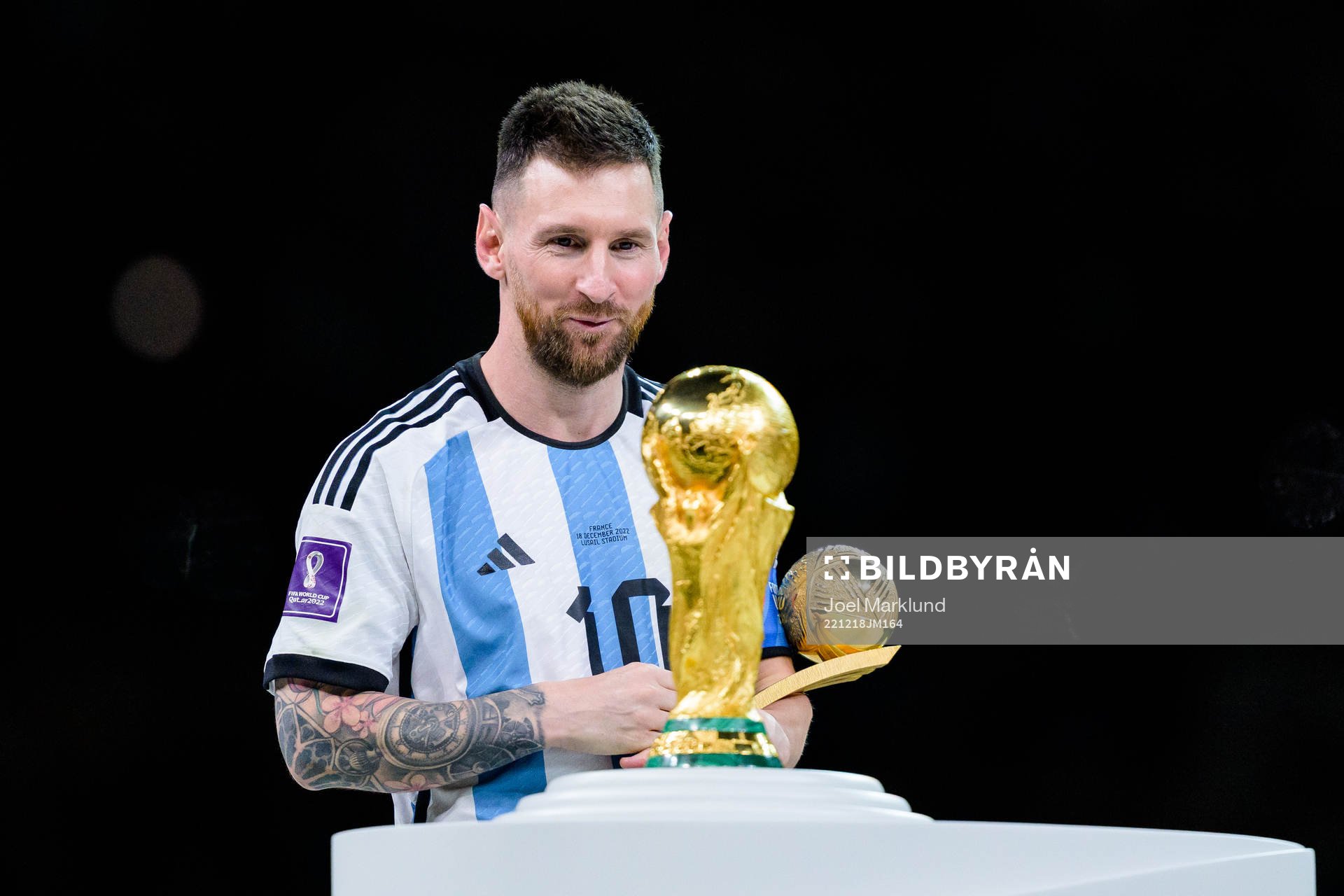 Lionel Messi of Argentina looks at the FIFA World Cup Trophy