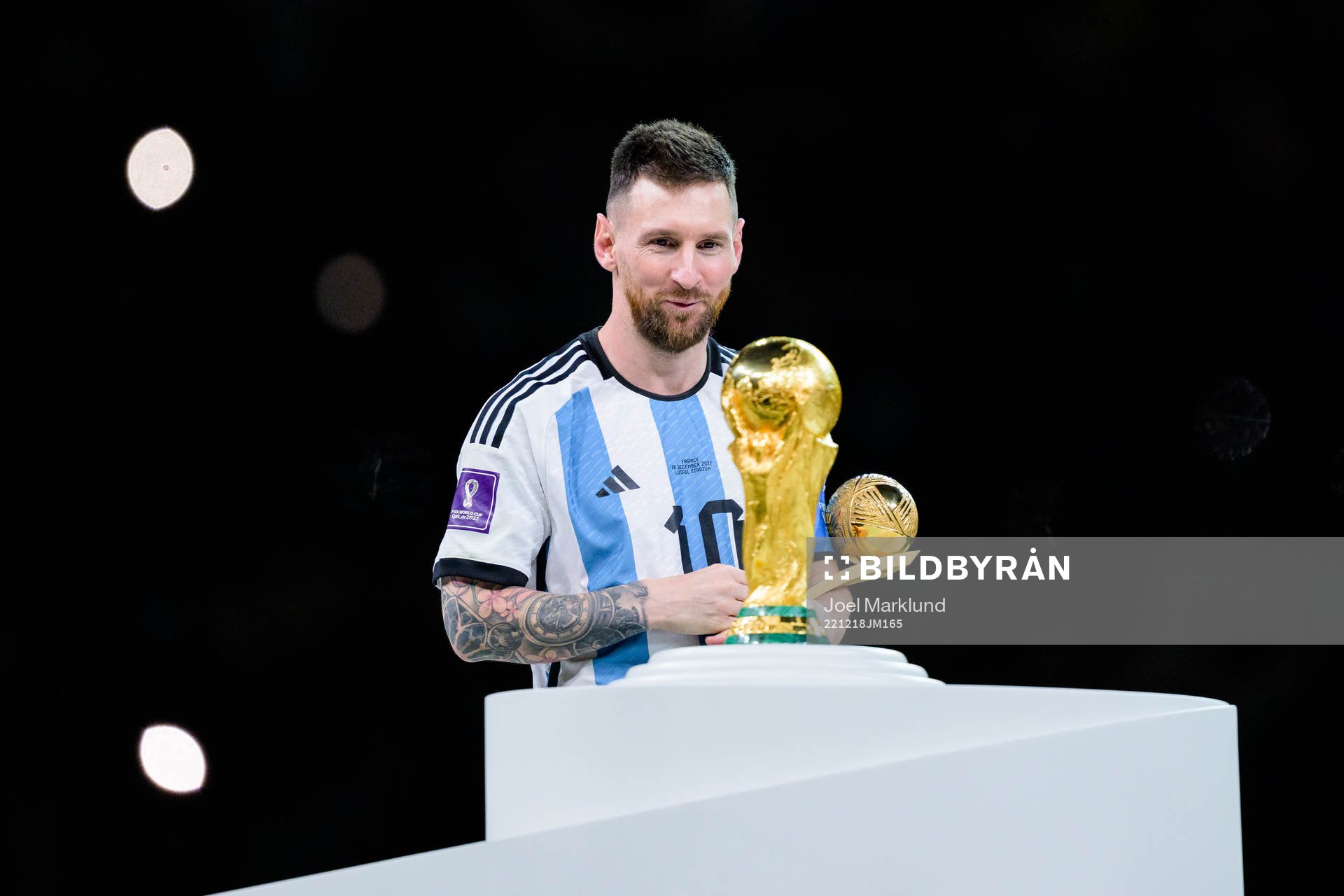 Lionel Messi of Argentina looks at the FIFA World Cup Trophy