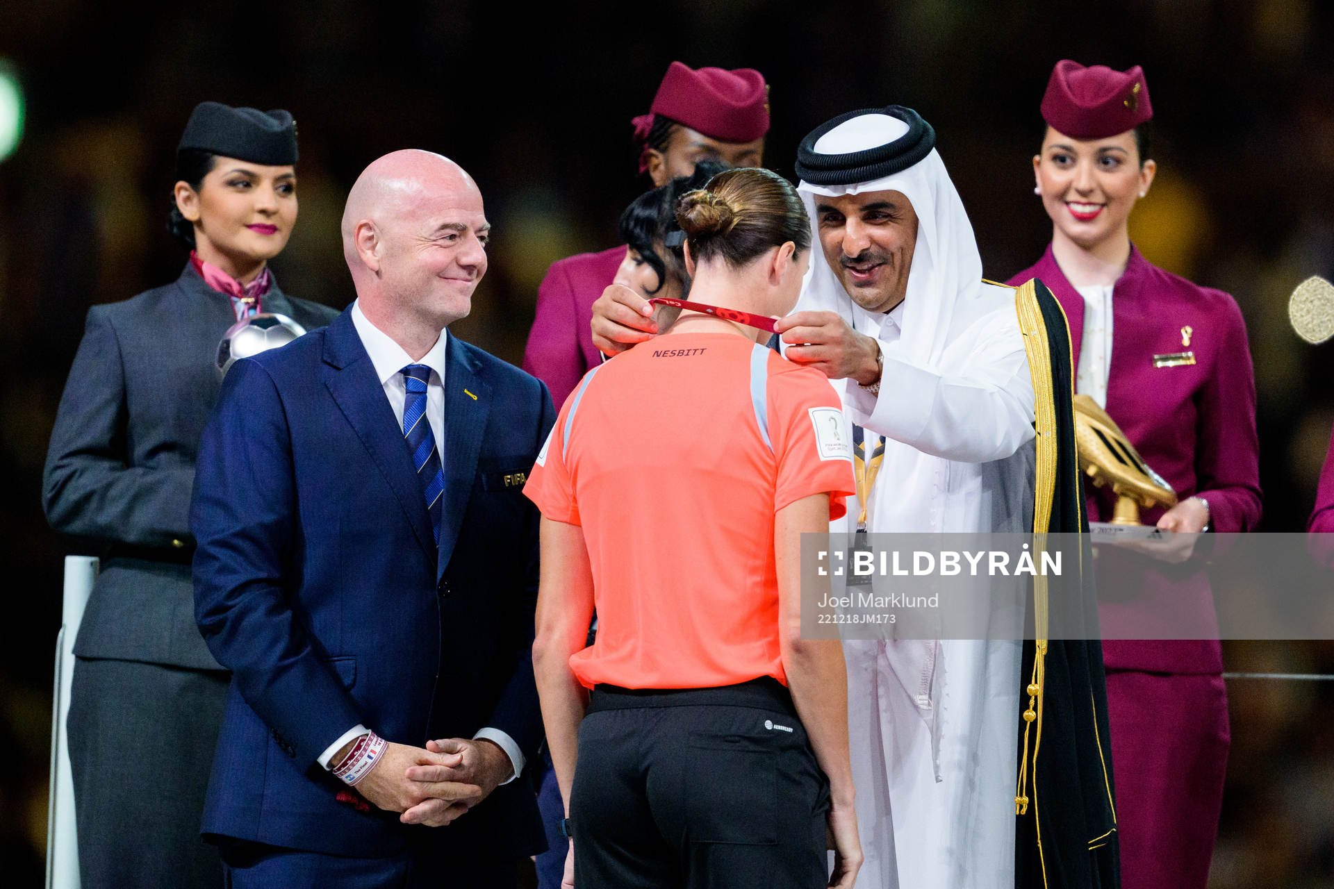 reserve assistant referee Kathryn Nesbitt is given a medal
