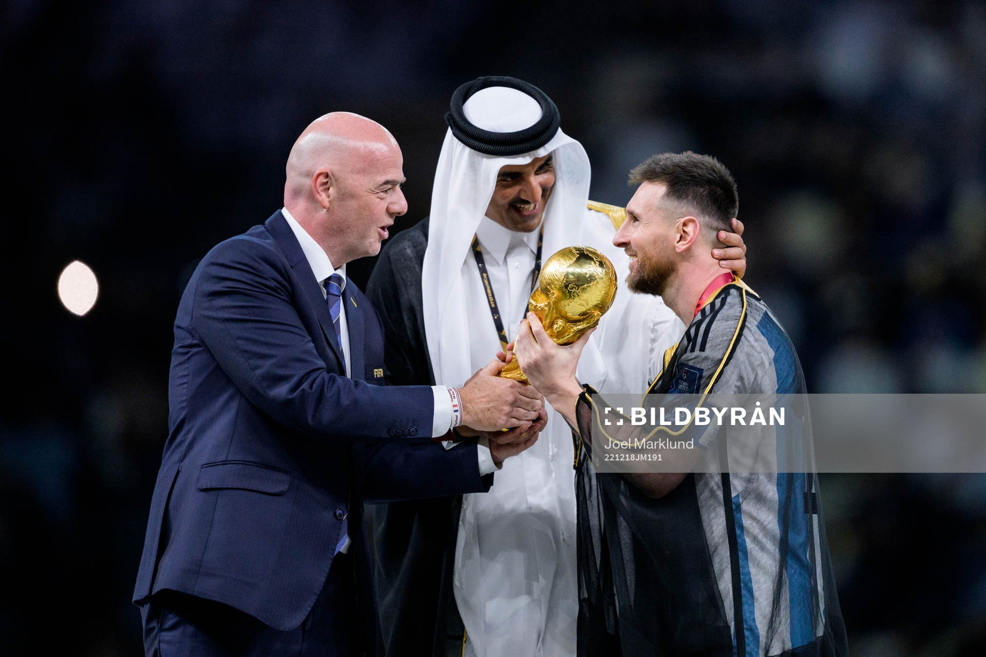 Lionel Messi of Argentina is handed the FIFA World Cup