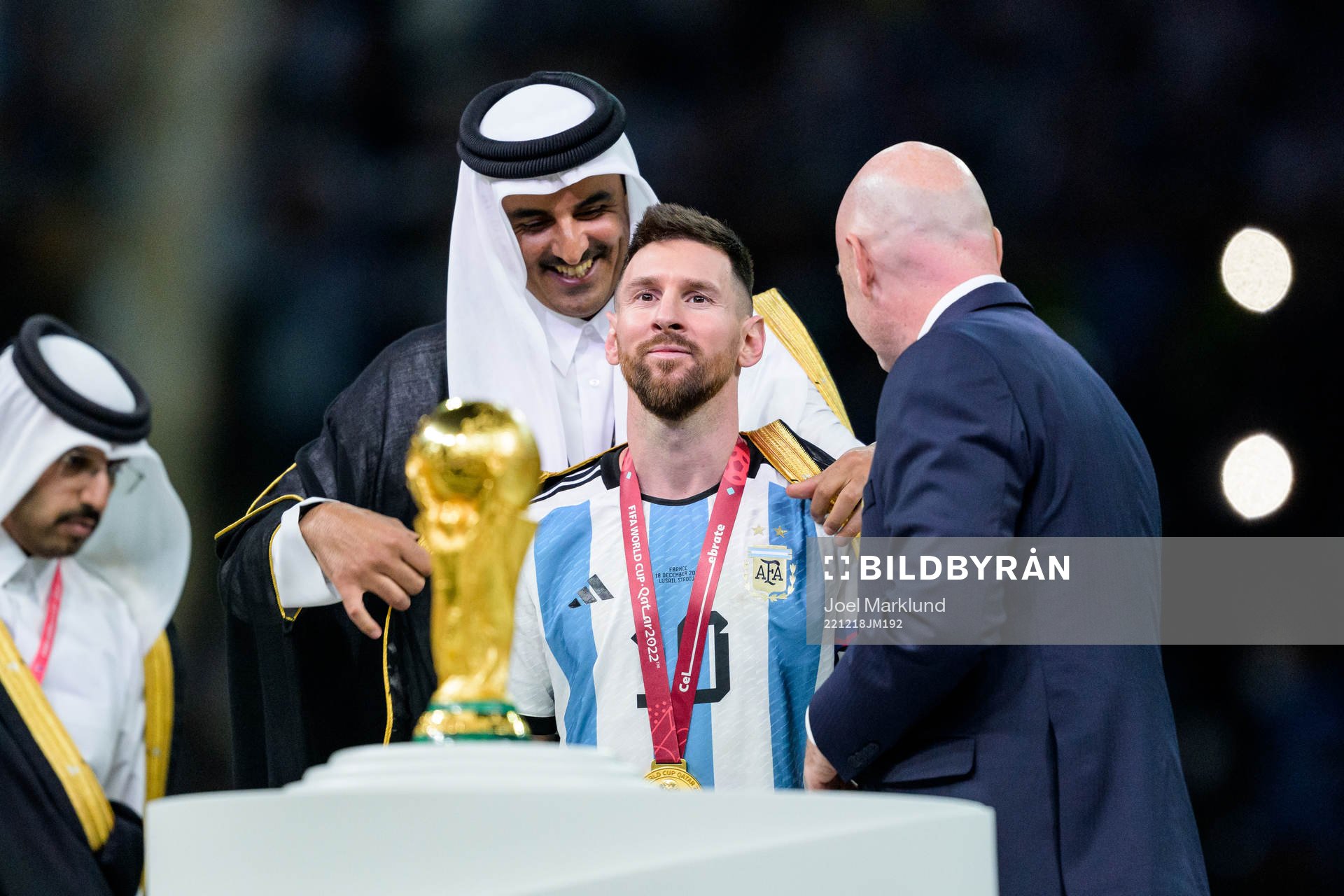 Lionel Messi of Argentina is handed a piece of clothing