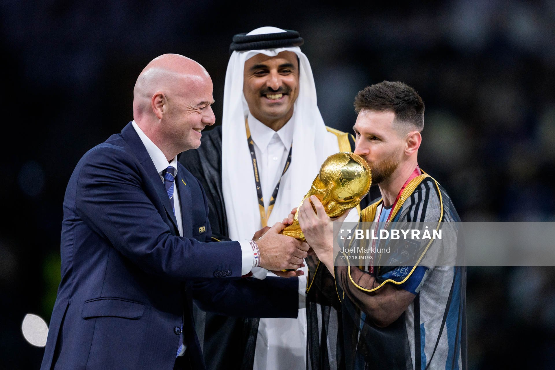 Lionel Messi of Argentina is handed the FIFA World Cup