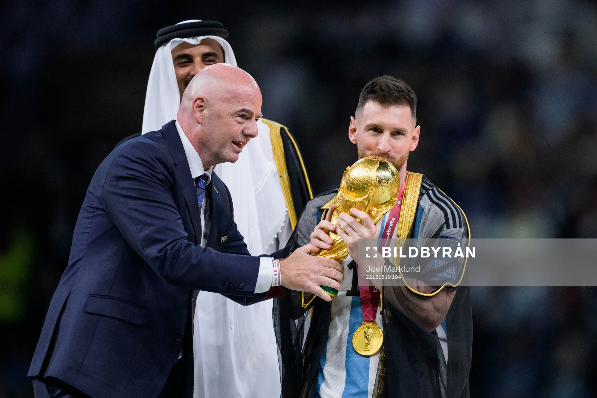 Lionel Messi of Argentina is handed the FIFA World Cup