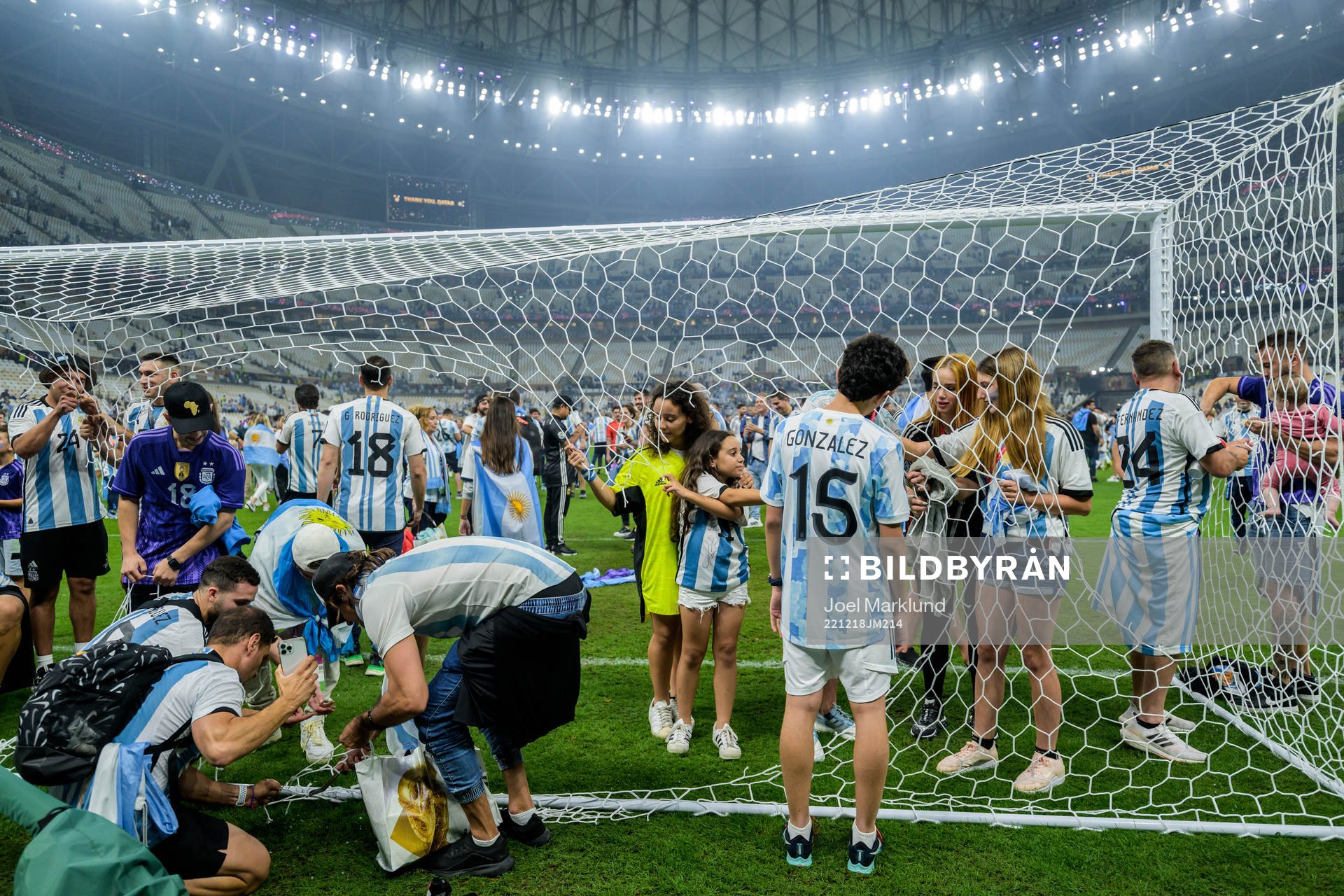 Family members of the Argentinian players cut the net of