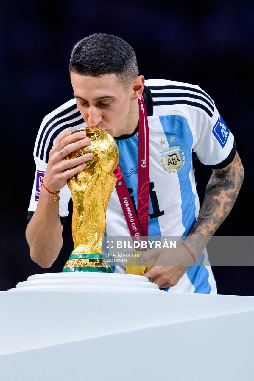Angel de Maria of Argentina kisses the FIFA World Cup trophy
