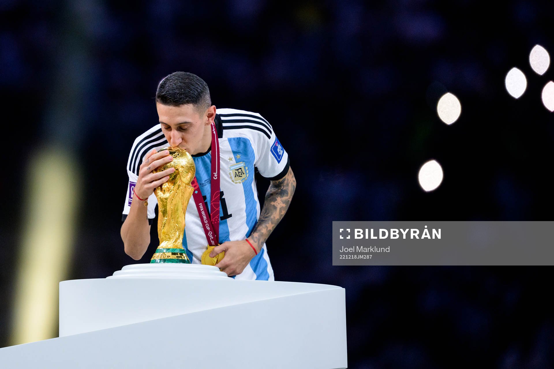 Angel de Maria of Argentina kisses the FIFA World Cup trophy