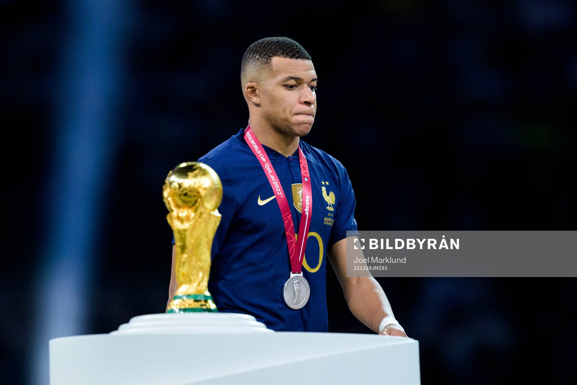 Kylian Mbappe of France looks dejected as he passes the